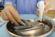 WHITEMAN AIR FORCE, Mo. - Airman Basic Kenneth Mason, 509th Medical Group dental clinic technician, cleans utensils used during wisdom tooth extraction, Tuesday. The dental techs uphold high sanitary standards to ensure every patient receives the best care possible.(U.S. Air Force photo/ Senior Airman Carlin Leslie)
