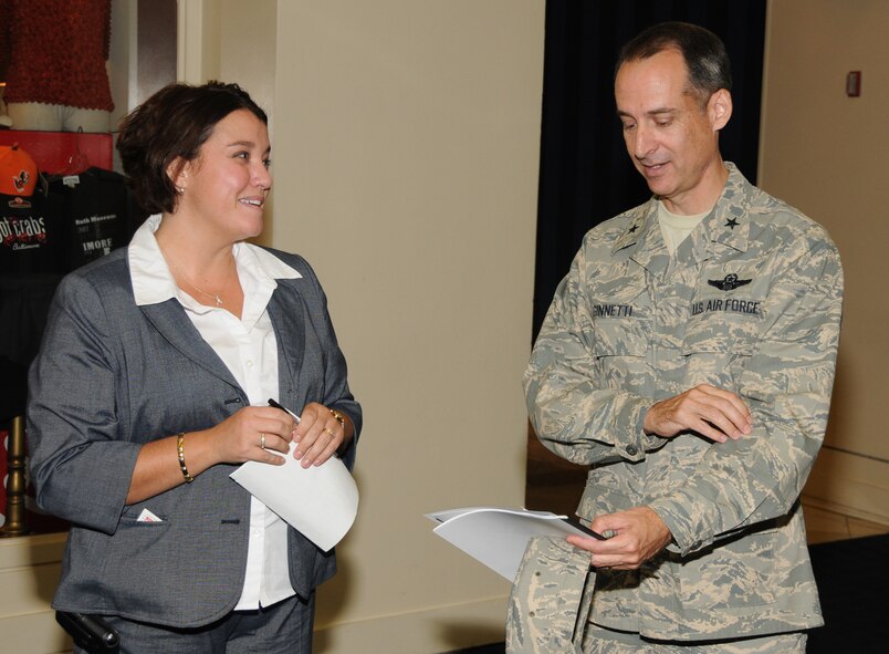 Mrs. Rebecca Price, Yellow Ribbon Reintegration Program coordinator and  Brig. Gen. Robert M. Ginnetti, chief of staff, Joint Force Headquarters, Maryland Air National Guard, discuss his opening remarks before he kick off the 30-day post-deployment YRRP event held at the Sheraton Baltimore City Center Hotel on July 9-10. (U.S. Air Force photo by Master Sgt. Ed Bard/Released) 