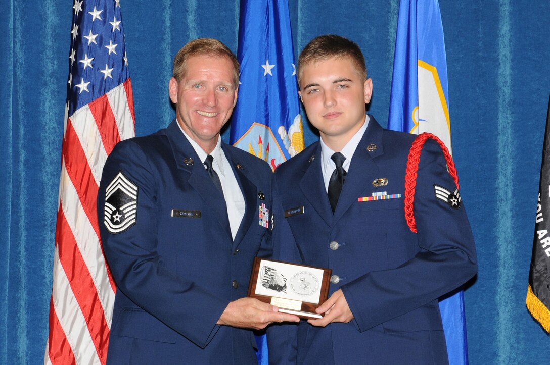 McGHEE TYSON AIR NATIONAL GUARD BASE, Tenn. - Senior Airman Tyler J. Herrman, a member of the 251st Combat Communications Group, Ohio Air National Guard, right, receives the distinguished graduate award for Airman Leadership School Class 10-4 at The I.G. Brown Air National Guard Training and Education Center here from Chief Master Sgt. Carl E. Collins, a chief enlisted manager at 1st Air Force, Tyndall AFB, Fla., July 2, 2010.  The distinguished graduate award is presented to students in the top ten percent of the class.  It is based on objective and performance evaluations, demonstrated leadership, and performance as a team player. (U.S. Air Force photo by Master Sgt. Kurt Skoglund/Released)