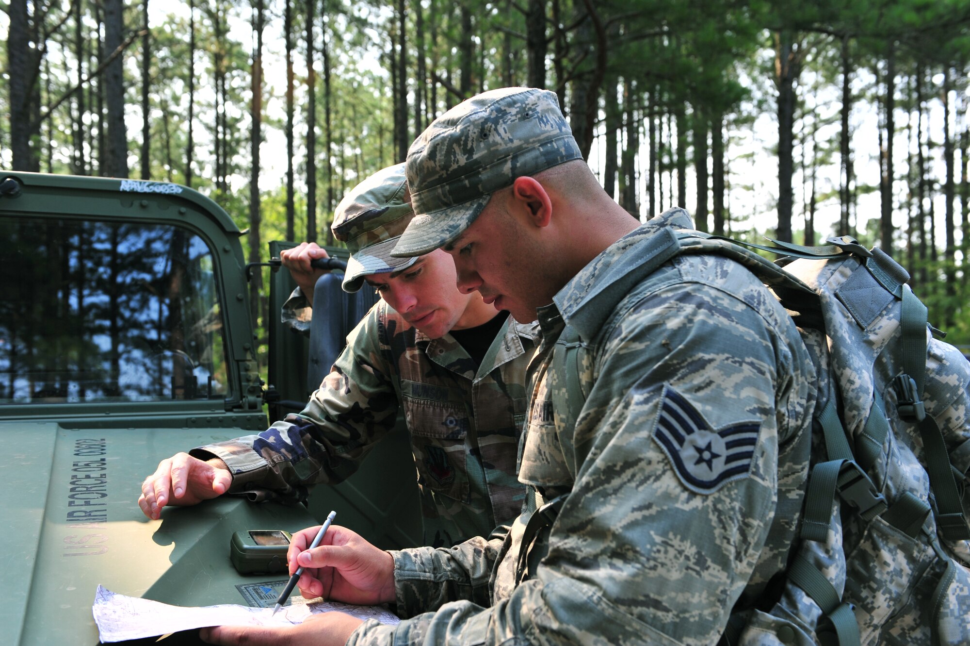 100708-F-8430J-176
SHAW AIR FORCE, S.C. - Senior Airman Michael Munson, 682nd Air Support Operations Squadron and tactical air control party, (left) and Staff Sgt. Wilfredo Godreau, 682nd ASOS power pro, plan a navigation route during a TACP exercise, July 7, 2010. Staff Sgt. Godreau participated in the exercises to renew his currencies, while Senior Airman Munson evaluated Sergeant Godreau's route. The TACP members arespecialists who are assigned to combat units. They advise ground forces on aircraft employment and capabilities, coordinate and control aerospace operation and participate in battle planning. (U.S. Air Force photo/Airman 1st Class Amber E. N. Jacobs)
