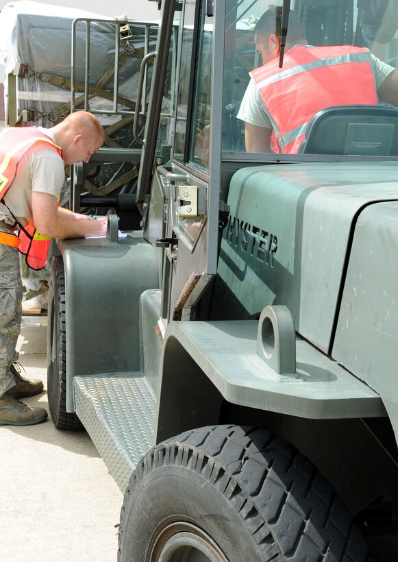 LANGLEY AIR FORCE BASE, Va. – Tech. Sgt. Troy Hosmer, 633d Logistics Readiness Squadron ramp coordinator, verifies pallet identifiers during a Cargo Deployment Function war day July 13.  The exercise is in preparation for the upcoming ORE.  (U.S. Air Force photo/Staff Sergeant Tabitha Kuykendall)