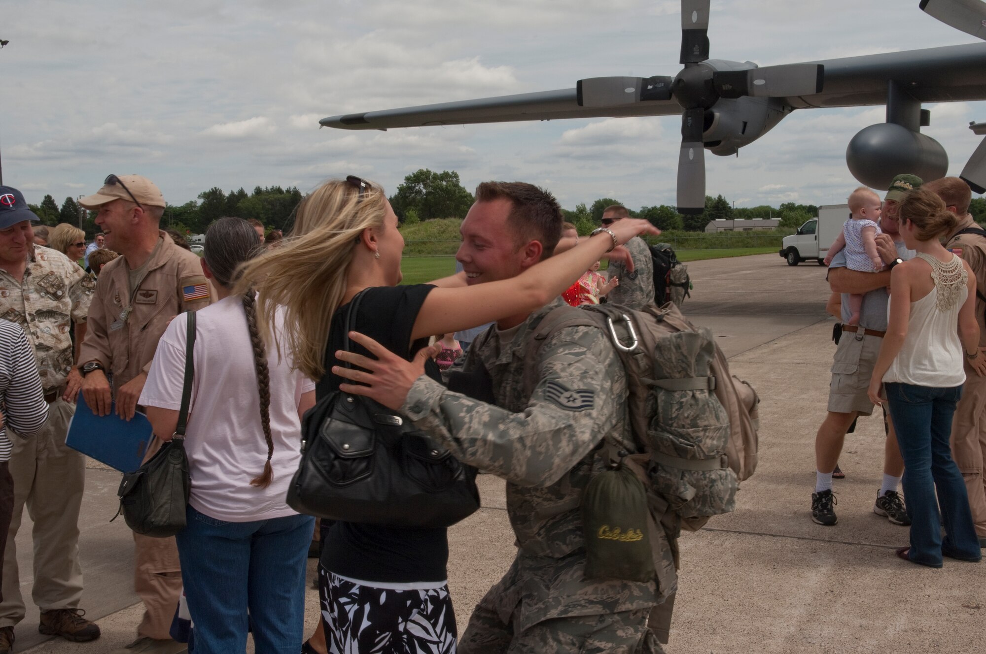 Friends and family excitedly greet Airmen disembarking from a C-130 "Hercules" at the Minneapolis-St. Paul International airport on July 11, 2010. The military cargo aircraft and about twenty Airmen are the first in a series of returns from Afghanistan during July for the 133rd Airlift Wing in 2010. USAF official photo by Senior Master Sgt. Mark Moss