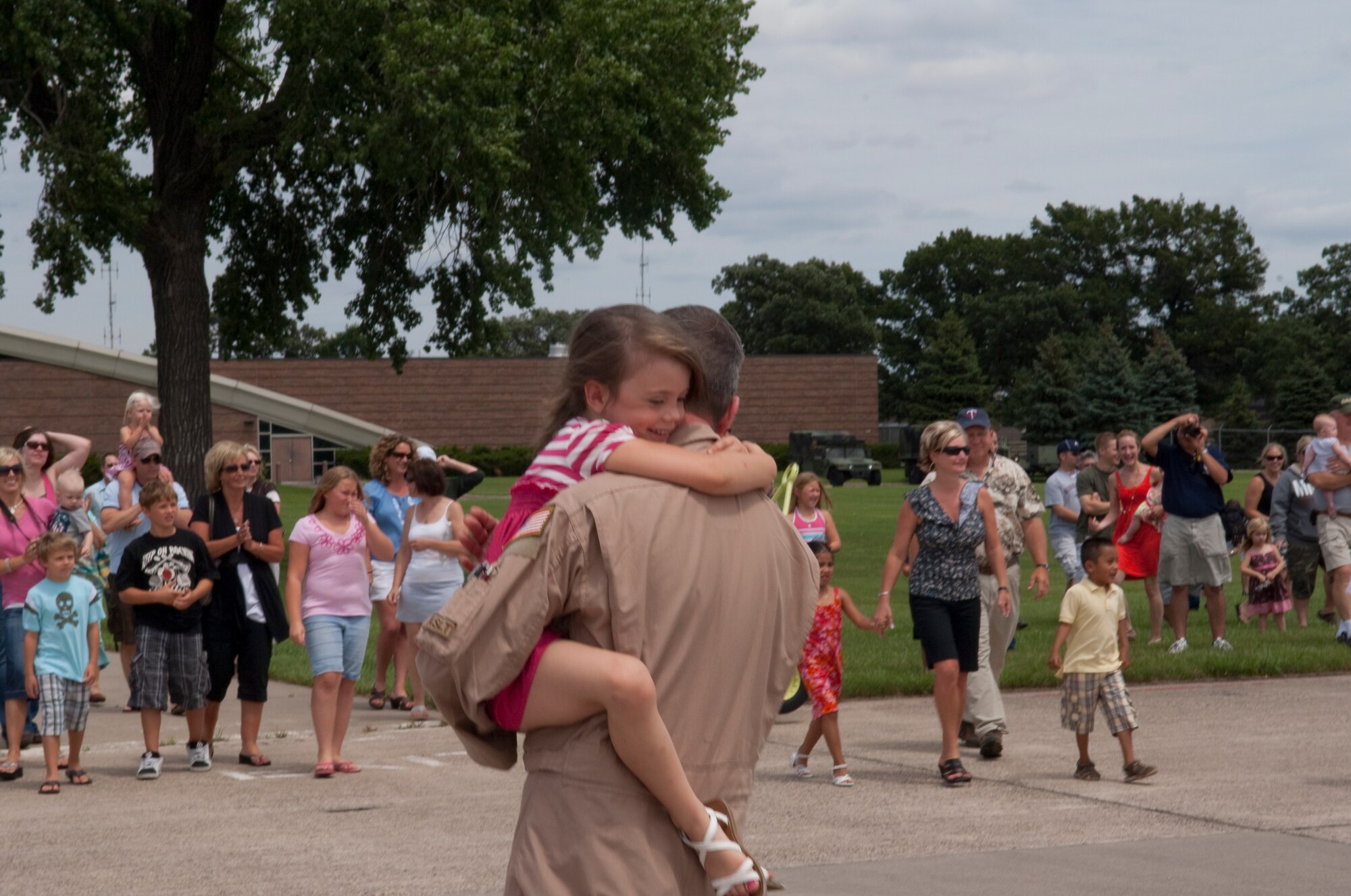 Friends and family excitedly greet Airmen disembarking from a C-130 "Hercules" at the Minneapolis-St. Paul International airport on July 11, 2010. The military cargo aircraft and about twenty Airmen are the first in a series of returns from Afghanistan during July for the 133rd Airlift Wing in 2010. USAF official photo by Senior Master Sgt. Mark Moss