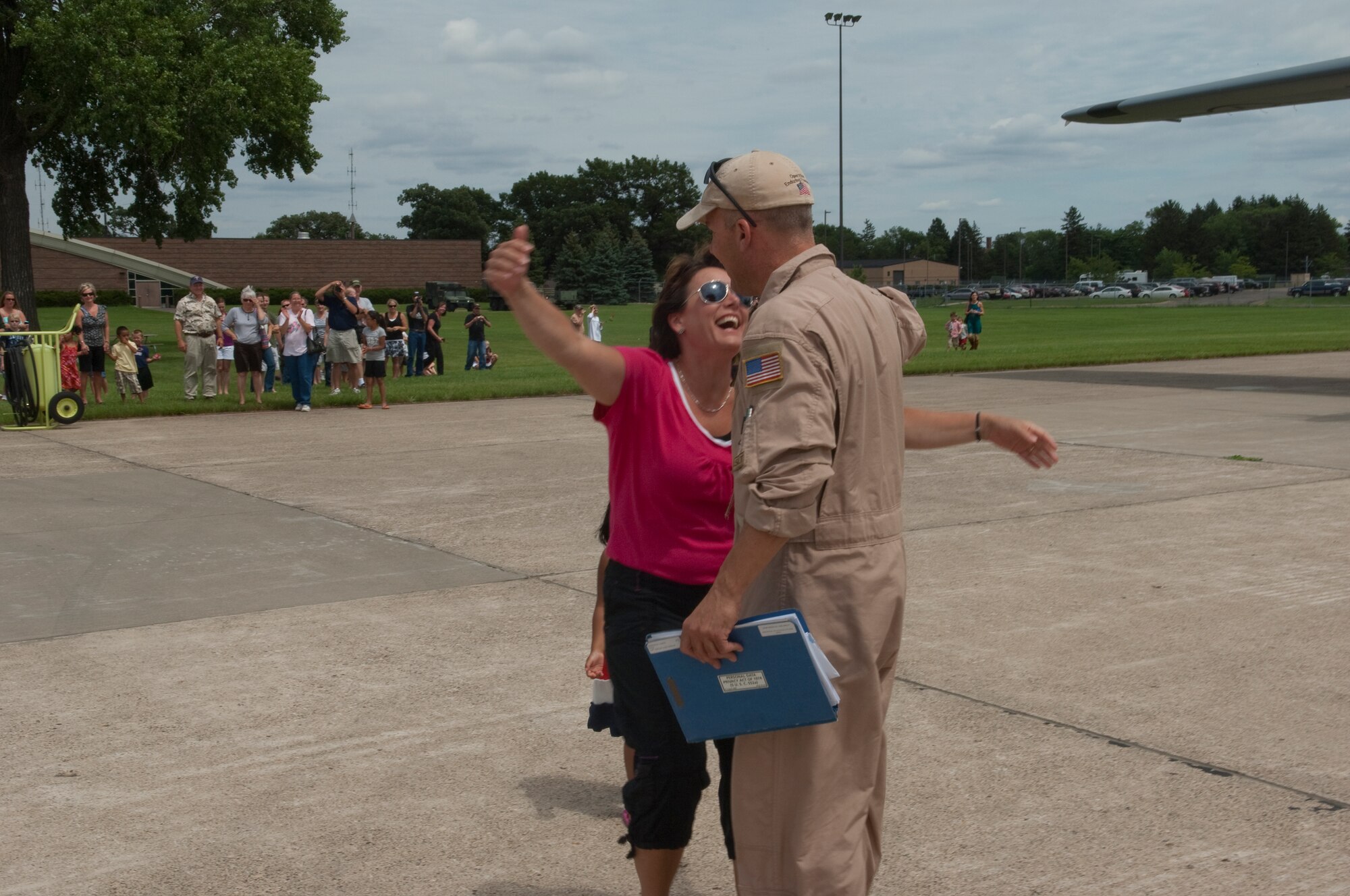 Friends and family excitedly greet Airmen disembarking from a C-130 "Hercules" at the Minneapolis-St. Paul International airport on July 11, 2010. The military cargo aircraft and about twenty Airmen are the first in a series of returns from Afghanistan during July for the 133rd Airlift Wing in 2010. USAF official photo by Senior Master Sgt. Mark Moss