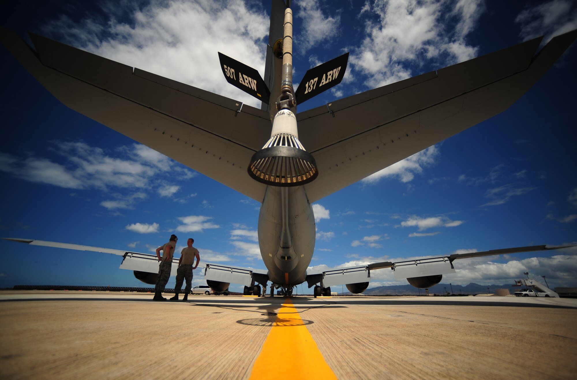 U.S. Air Force crew chiefs assigned to the 507th Aircraft Maintenance Squadron, Tinker Air Force Base, Okla., prepare a KC-135 Stratotanker for an air refueling mission during exercise Rim of the Pacific (RIMPAC) at Joint Base Pearl Harbor Hickam, Hawaii, July 9, 2010.  RIMPAC 2010 is the 22nd in a series of significant international combined/joint military exercises scheduled biennially by U.S. Pacific Fleet and takes place in the Hawaiian operating area.  RIMPAC training operations include participation by more than 14 nations, 34 ships, five submarines, more than 100 aircraft, and more than 20,000 Soldiers, Sailors, Marines and Airmen.  Multilateral exercises such as RIMPAC enhance cooperation between partnering nations and provide a unique opportunity to practice the ability to plan, communicate, and execute operations.  Shown in this photo is a 507th A?ir Refueling Wing KC-135R Stratotanker fitted with a drogue basket. The Drogue adapter is used when refueling Navy aircraft. (U.S. Air Force photo by Tech. Sgt. Jacob N. Bailey/Released)