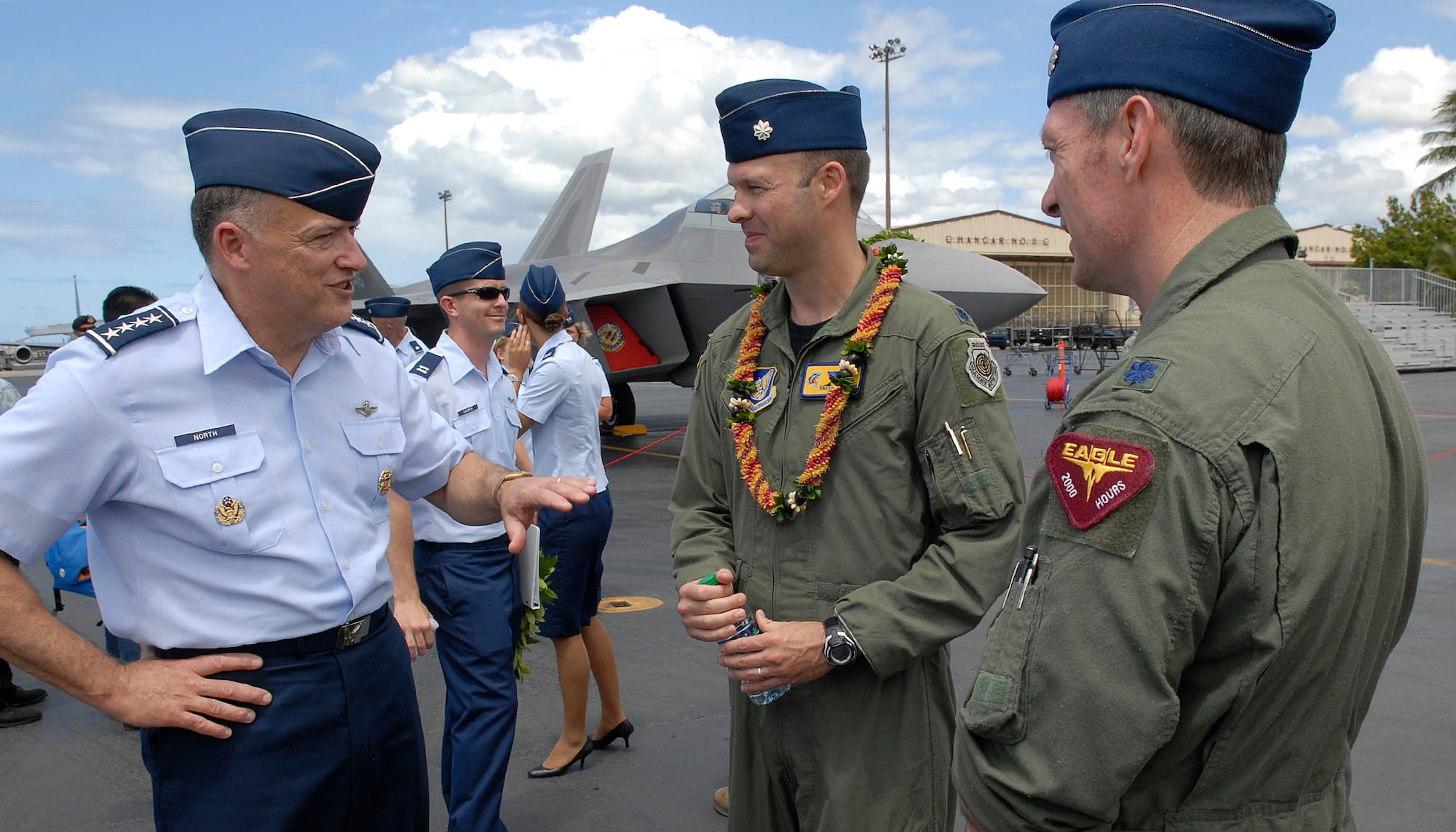 Gen. Gary North Commander Pacific Air Forces speaking with Lt. Col. Harvey Newton, pilot 19th Fighter Squadron thanking him for a job well done at flying the Air Force's newest fighter the F-22 Raptor to the opening ceremony for the F-22 Arrival Ceremony at Joint Base Pearl Harbor-Hickam, Hawaii, July 9, 2010. The 199th Fighter Squadron of the Hawaii Air National Guard is transitioning from the F-15 and will serve as the only Air National Guard led joint Guard and Active Duty squadron in the Pacific and the second in the U.S. Air Force. The Raptor represents an exponential leap in warfighting capabilities for U.S. forces in the Pacific. (U.S. Air Force photo/Tech Sgt. Jerome S. Tayborn