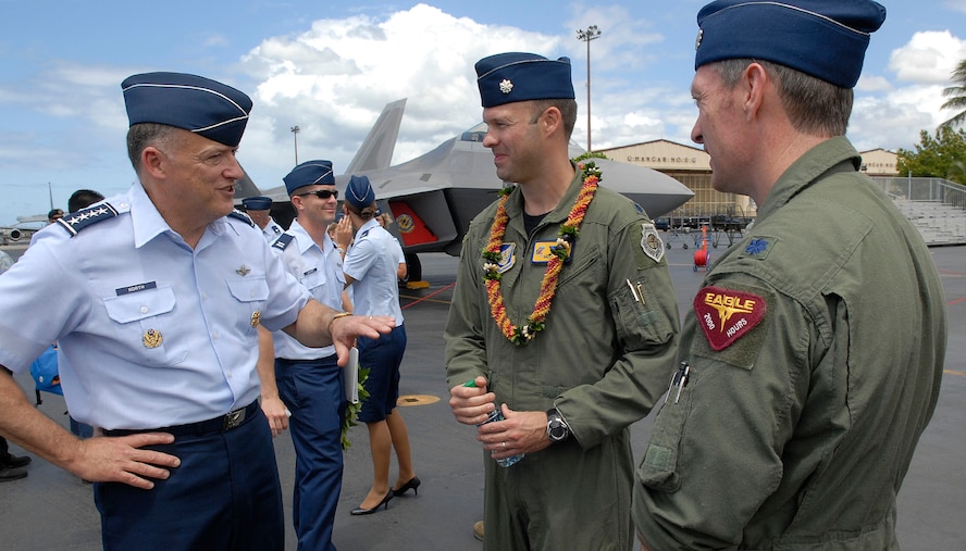 Gen. Gary North Commander Pacific Air Forces speaking with Lt. Col. Harvey Newton, pilot 19th Fighter Squadron thanking him for a job well done at flying the Air Force's newest fighter the F-22 Raptor to the opening ceremony for the F-22 Arrival Ceremony at Joint Base Pearl Harbor-Hickam, Hawaii, July 9, 2010. The 199th Fighter Squadron of the Hawaii Air National Guard is transitioning from the F-15 and will serve as the only Air National Guard led joint Guard and Active Duty squadron in the Pacific and the second in the U.S. Air Force. The Raptor represents an exponential leap in warfighting capabilities for U.S. forces in the Pacific. (U.S. Air Force photo/Tech Sgt. Jerome S. Tayborn