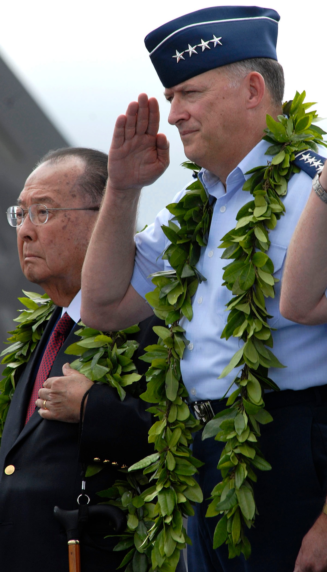 Senator Daniel K. Inouye and Gen. Gary North Commander, Pacific Air Forces, render respect to the flag during the opening ceremony for the F-22 Raptors Arrival Ceremony at Joint Base Pearl Harbor-Hickam, Hawaii, July 9, 2010. The F-22 Raptor is the Air Force's newest fighter aircraft. Its combination of stealth, supercruise, maneuverability, and integrated avionics, coupled with improved supportability, represents an exponential leap in warfighting capabilities. The ceremony marks the beginning of the partnership between the Hawaii Air National Guard and the active duty Air Force flying the fifth generation fighter at Hickam. The F-22 Raptors are assigned to the 199th Fighter Squadron, 154th Wing, Hawaii Air National Guard and the 19th Fighter Squadron, 15th Wing. The Raptor represents an exponential leap in warfighting capabilities for U.S. forces in the Pacific. (U.S. Air Force photo/Tech Sgt. Jerome S. Tayborn
