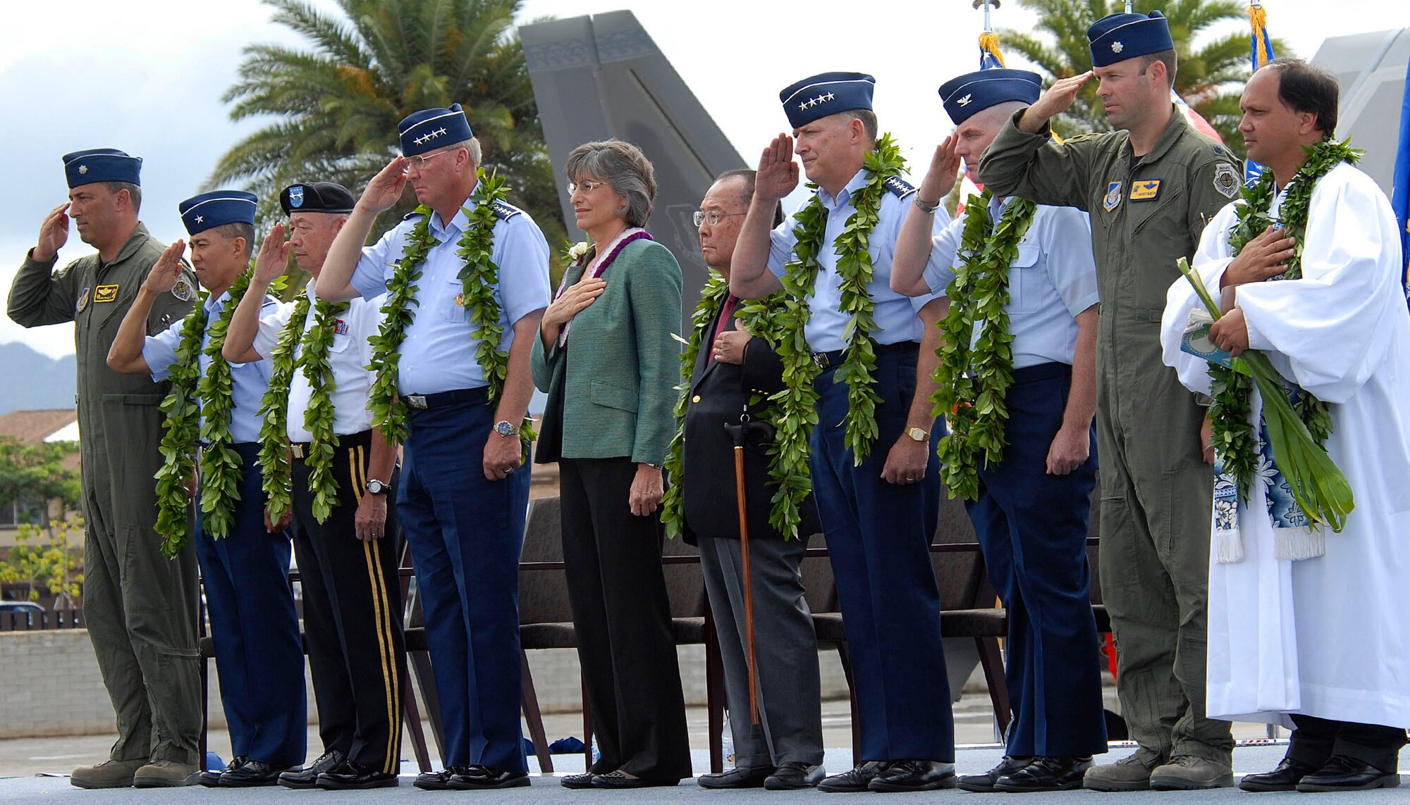 (From left to right) Air National Guard leadership, Governor Linda Lingle, Senator Daniel K. Inouye, Headquarters Pacific Air Forces leadership, and Kahu Kordell Kekoa render respect to the flag during the opening ceremony for the F-22 Raptors Arrival Ceremony at Joint Base Pearl Harbor-Hickam, Hawaii, July 9, 2010. The F-22 Raptor is the Air Force's newest fighter aircraft. Its combination of stealth, supercruise, maneuverability, and integrated avionics, coupled with improved supportability, represents an exponential leap in warfighting capabilities. The ceremony marks the beginning of the partnership between the Hawaii Air National Guard and the active duty Air Force flying the fifth generation fighter at Hickam. The F-22 Raptors are assigned to the 199th Fighter Squadron,154th Wing, Hawaii Air National Guard and the 19th Fighter Squadron, 15th Wing. The Raptor represents an exponential leap in warfighting capabilities for U.S. forces in the Pacific. (U.S. Air Force photo/Tech Sgt. Jerome S. Tayborn)