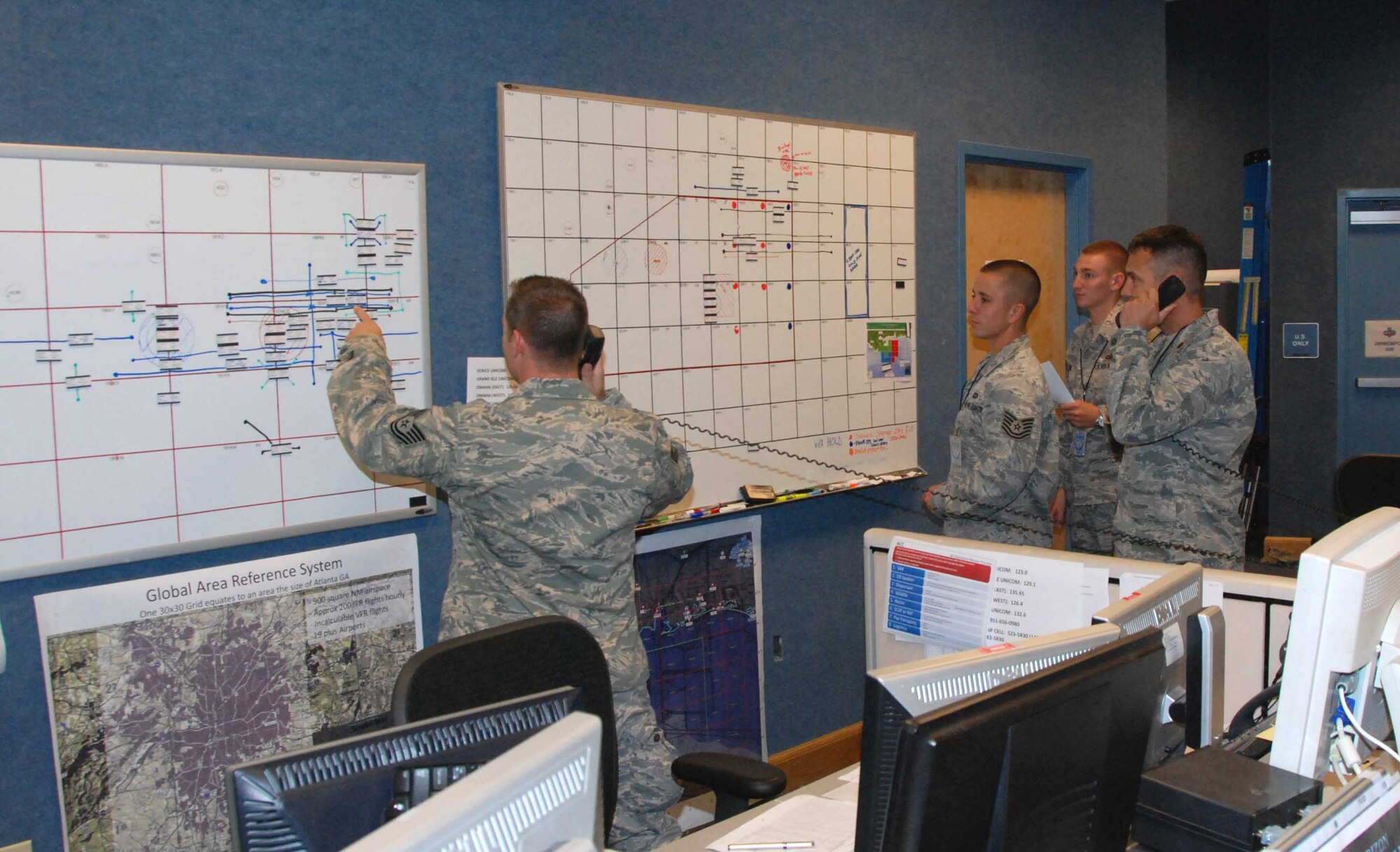 From left:  Tech. Sgt. Edward Noel, Tech. Sgt. Charles Holbert, Staff Sgt. Troy Bame, and Maj. Dwayne Gray, Aviation Coordination Command airspace managers, work on air support schedules in response to the Deepwater Horizon clean-up efforts in the Gulf of Mexico.