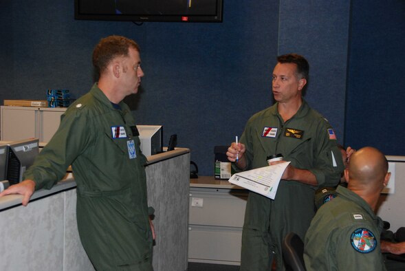TYNDALL AIR FORCE BASE, Fla. -- U.S. Coast Guard Cmdr. Andrew Cromwell, Aviation Coordination Command deputy director (left), and U.S. Coast Guard Capt. Mike Emerson, ACC director, discuss Deepwater Horizon Response air operations. (U.S. Air Force photo/Maj. Steve Burke)