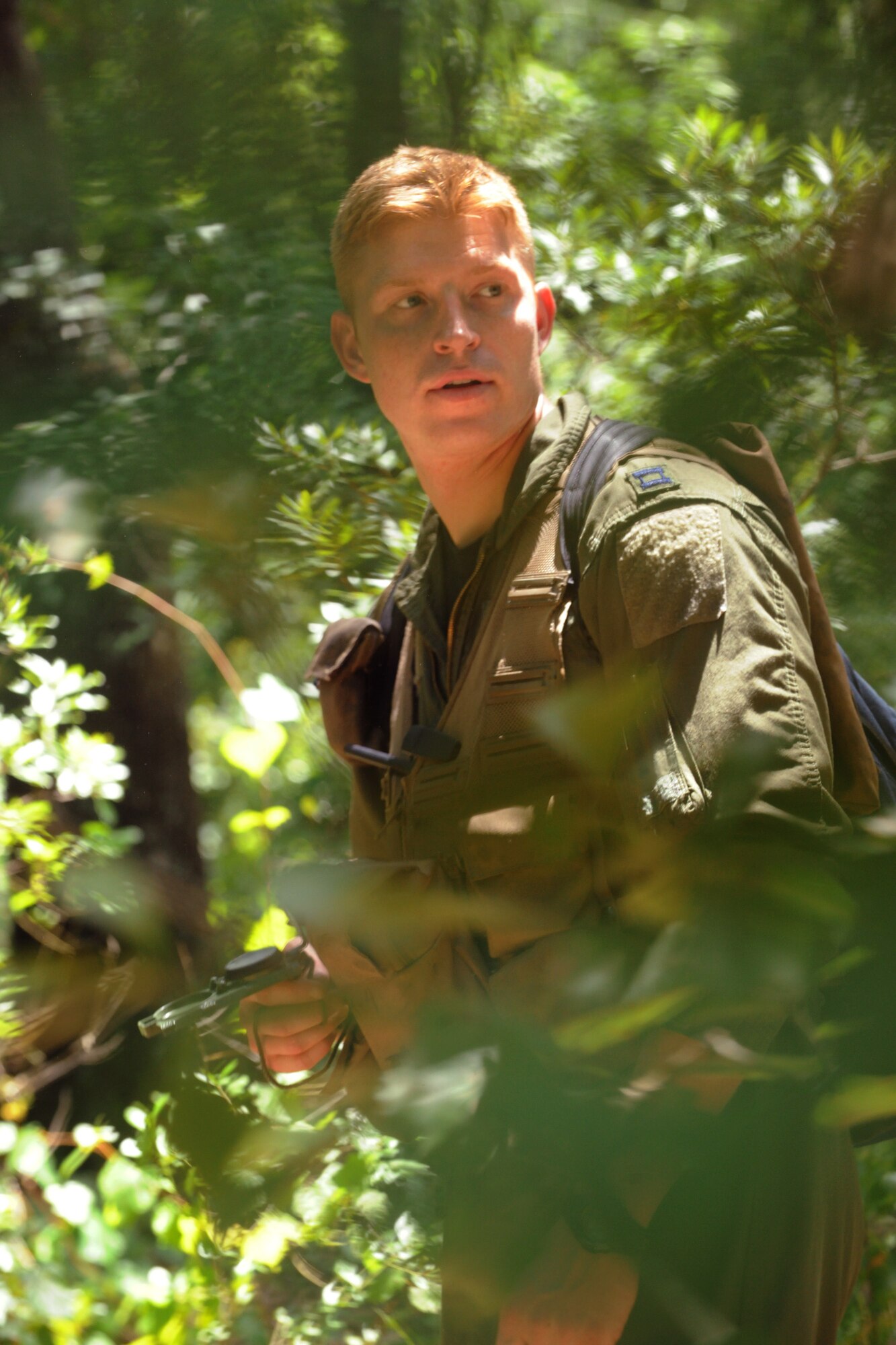 MOODY AIR FORCE BASE, Ga. -- Capt. James Buchannan, 75th Fighter Squadron A-10 Thunderbolt II pilot, navigates through the woods with his compass during survival, evasion, resistance and escape training here July 6. The group participated in four hours of classroom training and then more than 10 hours of hands-on training. (U.S. Air Force photo by Airman 1st Class Benjamin Wiseman/RELEASED)