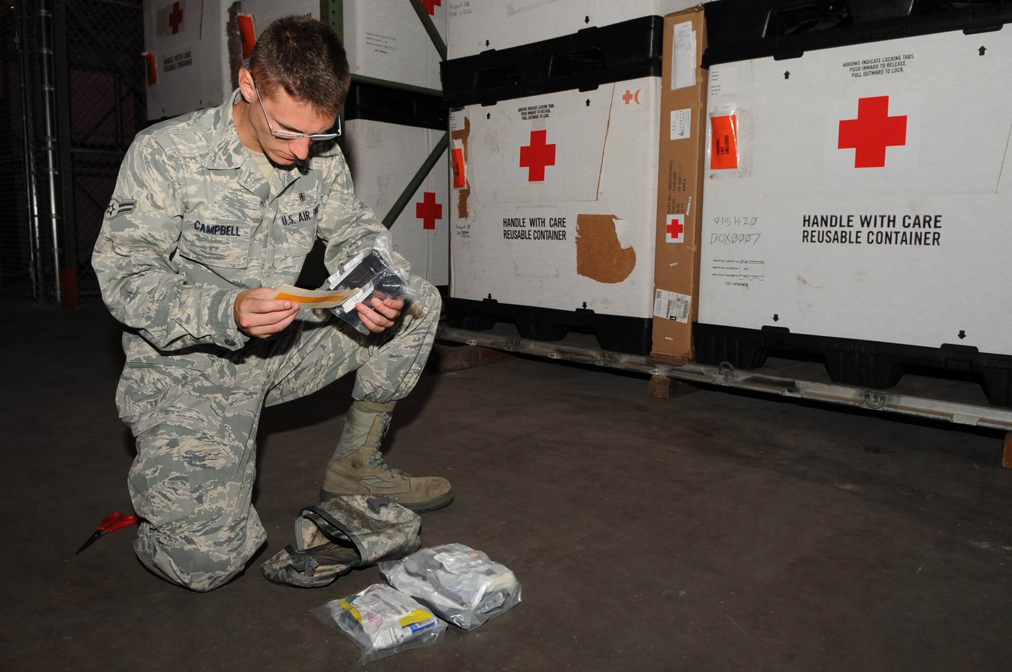 SEYMOUR JOHNSON AIR FORCE BASE, N.C. -- Airman 1st Class Matthew Campbell checks lot numbers of received individual first aid kit against ID tag here July 12, 2010. Prior to distribution, kits are checked to verify all items are accounted for, up-to-date and serviceable. Airman Campbell, 4th Medical Support Squadron medical logistic technician, hails from Milford, Del. (U.S. Air Force photo/ Staff Sgt. Courtney Richardson)(RELEASED)