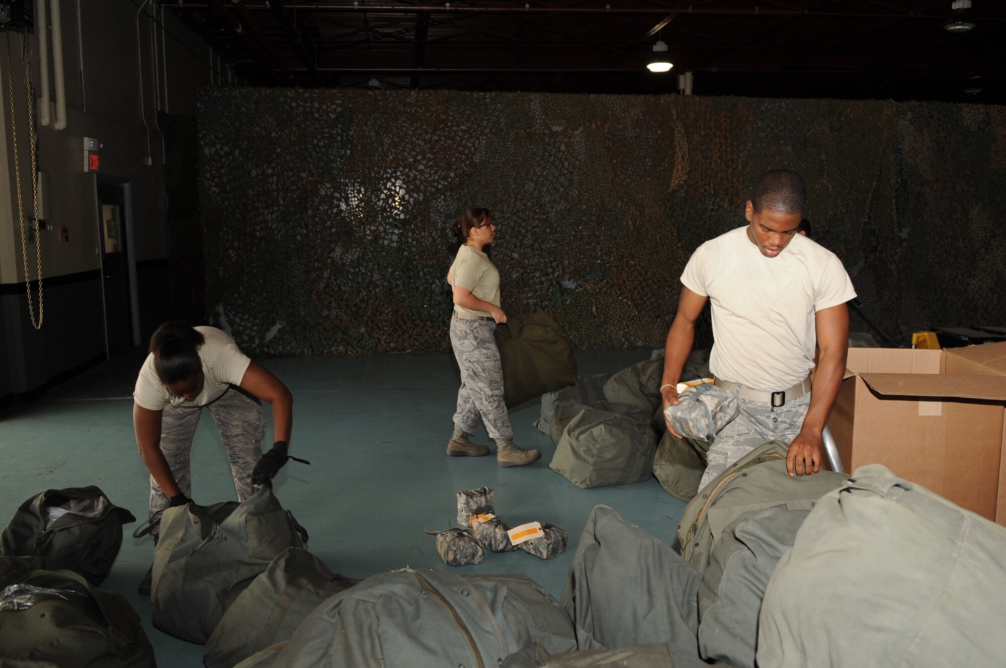 SEYMOUR JOHNSON AIR FORCE BASE, N.C. -- Airmen from the 4th Logistic Readiness Squadron add first aid kits to Charlie bags in preparation for the upcoming operational readiness exercise here July 12, 2010. During all exercises and real-world deployments, the 4th LRS is responsible for distributing all personal protective equipment and weapons. (U.S. Air Force photo/ Staff Sgt. Courtney Richardson)(RELEASED)