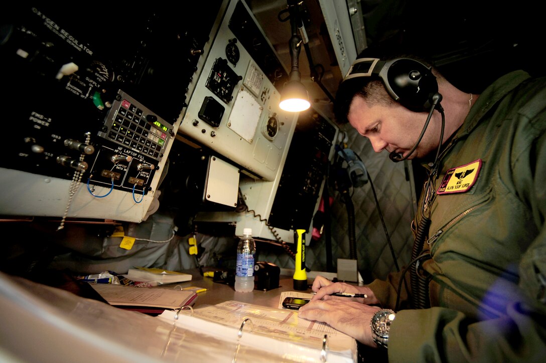 Master Sgt. Alvin Kuper completes a pre-flight checklist aboard a KC-135 Stratotanker for an air refueling mission in support of the Rim of the Pacific exercise July 10, 2010, over the Pacific Ocean. Sergeant Kuper is a boom operator assigned to the 465th Air Refueling Squadron at Tinker Air Force Base, Okla. (U.S. Air Force photo/Staff Sgt. Kamaile O. Long)