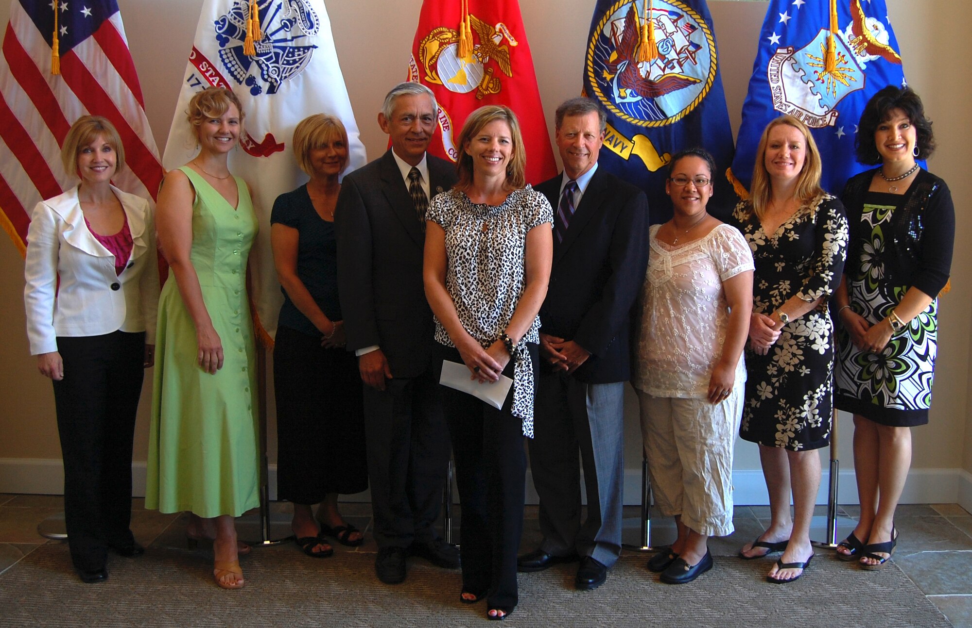 Friends of the Fallen volunteers and Robin Raine, Families of the Fallen support branch chief, pose with Ron Winter, former Secretary of the Air Force Manpower and Reserve Affairs, and the Honorable Craig W. Deuhring, former Assistant SAF/MR, June 25 in the foyer of the Center for Families of the Fallen. Mr. Winter and Mr. Deuhring presented the Friends of the Fallen organization with a $5,000 donation on behalf of the A.J. and Lynda Scribante Charitable Foundation. (U.S. Air Force photo/Senior Airman Andrew Helmkamp)