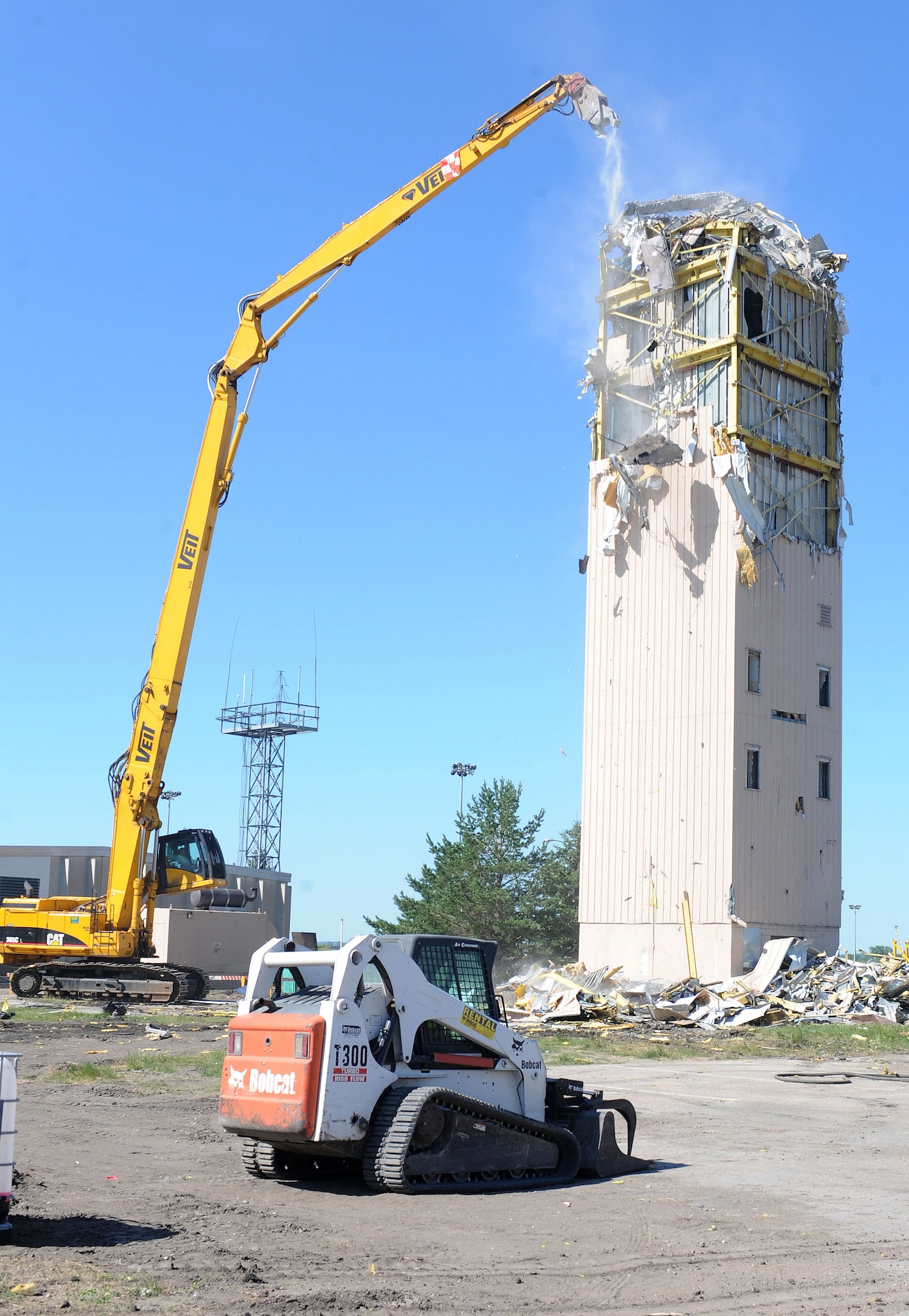 Contractors use heavy equipment to tear down the old air traffic control tower next to the flightline July 9, on Grand Forks Air Force Base, N.D.  The old tower has been replaced with a $13 million co-located air traffic control facility. The new facility will provide space to expand ATC capabilities to support future missions. (U.S. Air Force photo/Staff Sgt. Suellyn F. Nuckolls)