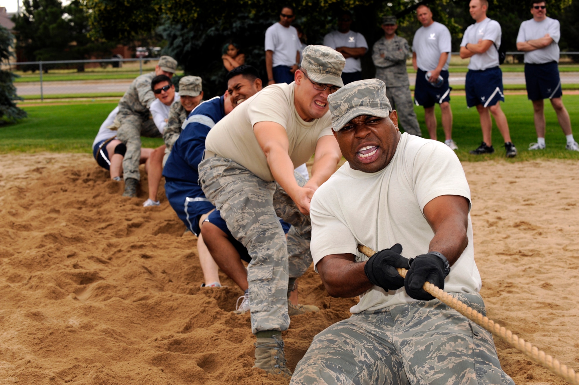 Staff Sgt. Cedrick Killings, 21st Civil Engineer Squadron, leads his team during the tug-of-war competition at the 2010 Peterson Air Force Base Sports and Field day July 8. More than 2,500 people from units across the base participated in games of skill, finesse and athletic ability, and strengthened their camaraderie during the annual event. (U.S. Air Force photo/Craig Denton) 