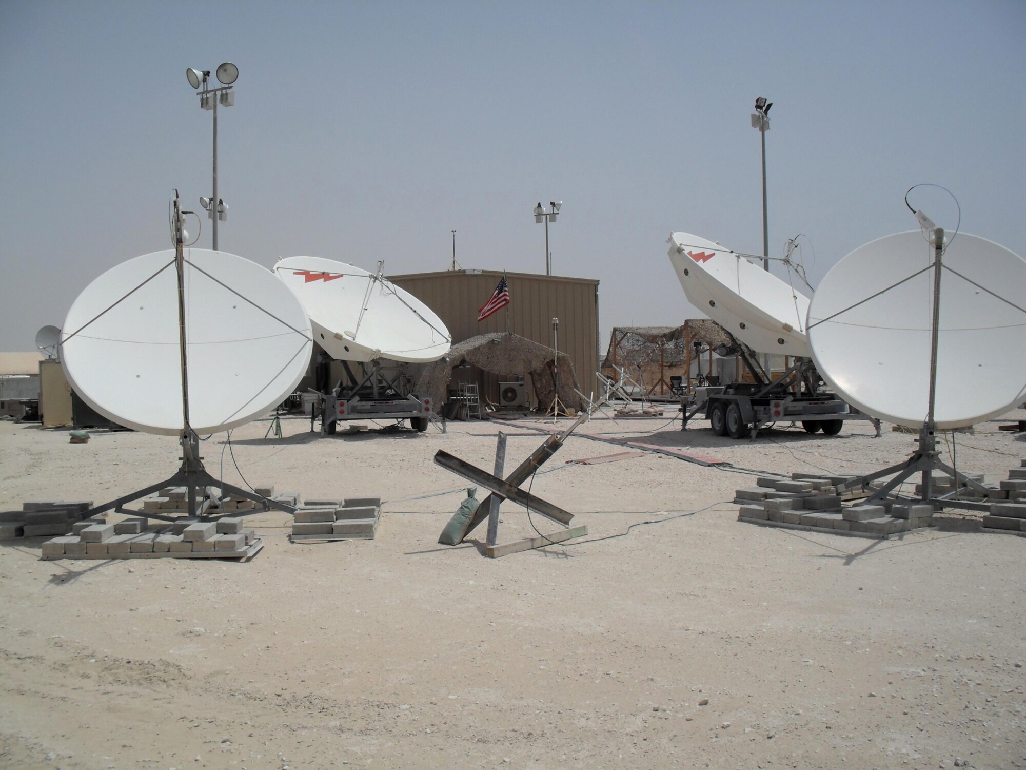 Airmen of the 16th and 380th Space Control Squadrons use Rapid Attack Identification Detection Reporting System Deployable Ground Segment Zero antennas to detect interference on mission critical satellite communication links in Southwest Asia. Members of the 16th and 380th Space Control Squadrons achieved a milestone recently when their deployed mission, Operation Silent Sentry, surpassed five years of continuous deployed operations. (U.S. Air Force photo)