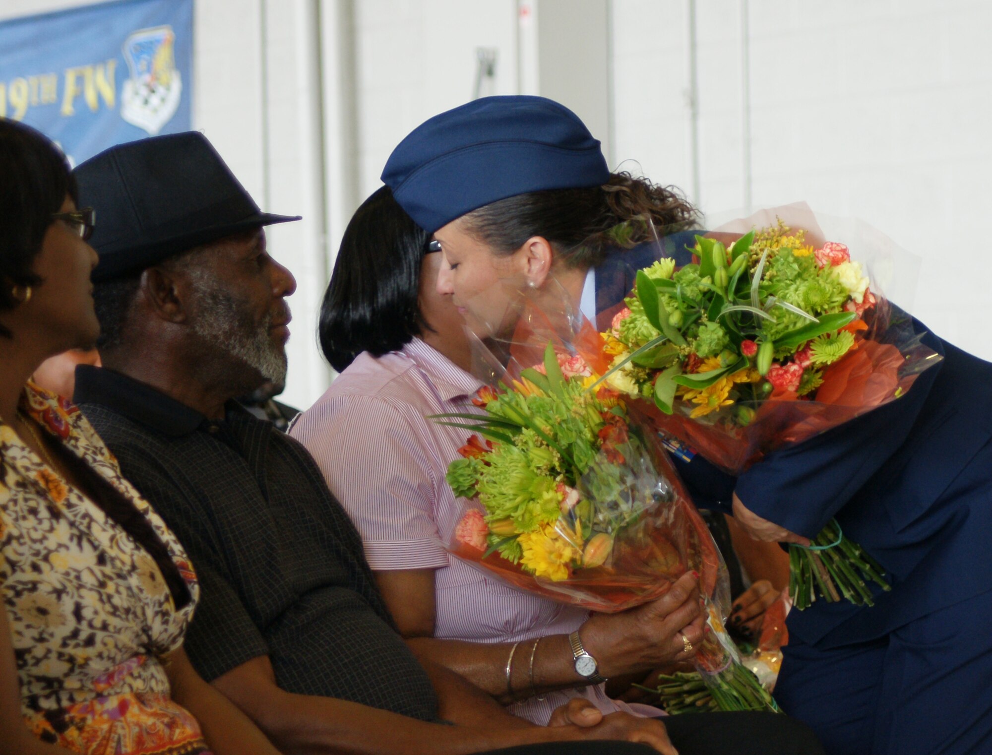 Chief Master Sgt. Elizabeth Atismé, 419th Fighter Wing command chief, embraces her mother, Ms. Beatrice Terrence, as she presents flower in appreciation of her family’s support of her military career. (U.S. Air Force photo/Staff Sgt. Alan Schultz) 