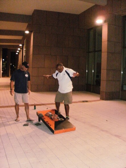 WRIGHT-PATTERSON AIR FORCE BASE, Ohio – Master Sgt. Jon Winters, 89th Airlift Squadron, and fellow crewmembers had the opportunity to play a game of cornhole with Cincinnati Bengals coach Marvin Lewis during some downtime at Ramstein Air Base, Germany. Four NFL coaches participating in the NFL-USO Coaches tour at the end of June met with military members serving overseas. (U.S. Air Force photo/Master Sgt. Chuck Fritz)