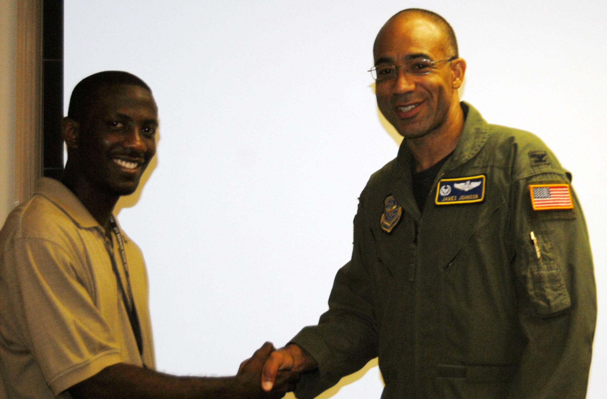 Col. James Johnson, 43rd Airlift Wing Commander, presented his Commander’s Coin to Irvin Gourdine, 43rd AW, Visual Information, June 29, for his exceptional performance beyond the call of duty.  Mr. Gourdine is a graphic design artist and base photographer for Pope, and was handpicked to design the Pope Haiti book. (U.S. Air Force Photo/1st Lt. Cammie Quinn)