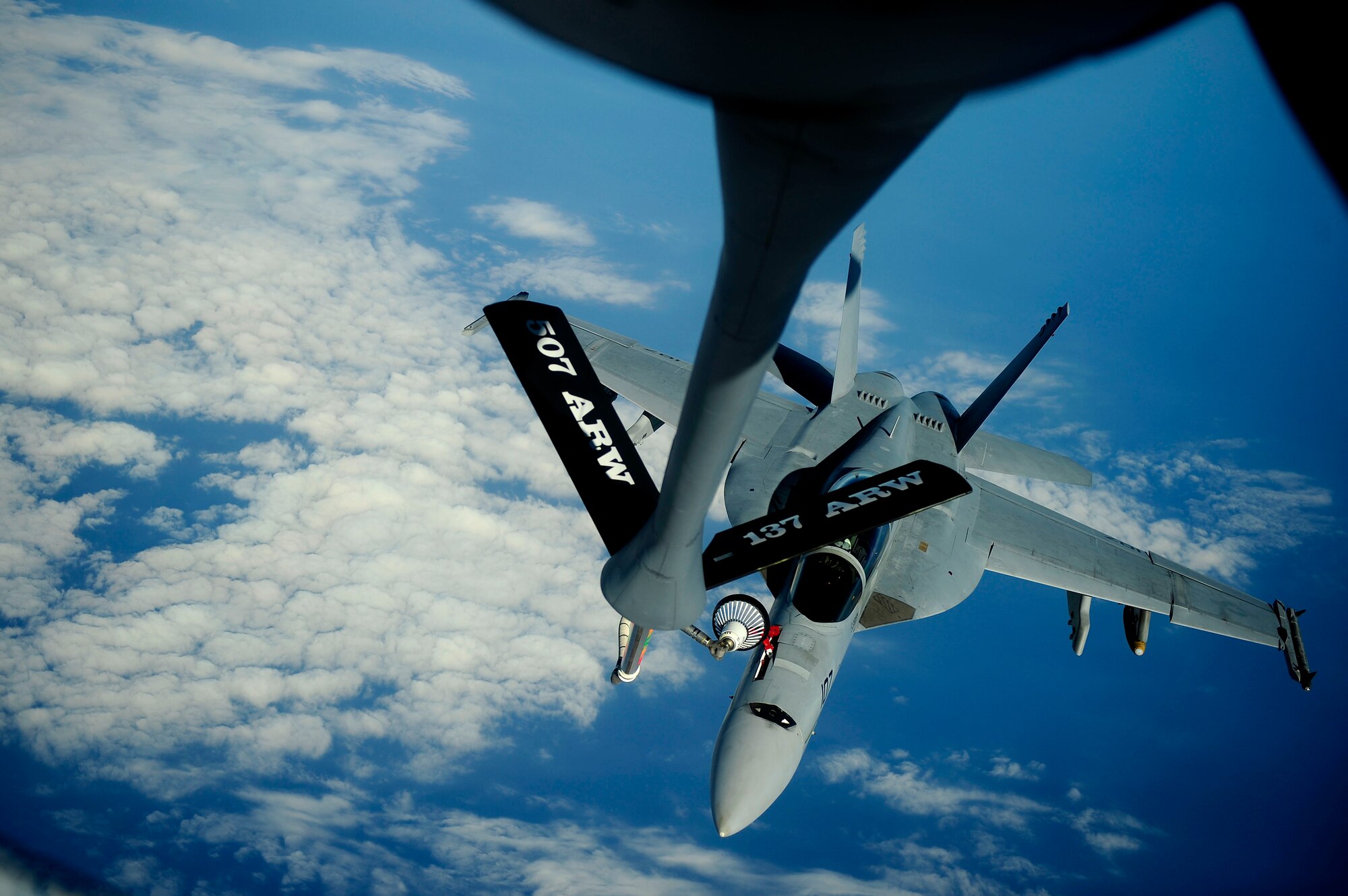 PEARL HARBOR (July 8, 2010) A KC-135 Stratotanker assigned to 465th Air Refueling Squadron, 507th Air Refueling Wing, delivers fuel to an F/A-18F Super Hornet assigned to the Black Knights of Strike Fighter Squadron (VFA) 154 supporting Rim of the Pacific (RIMPAC) 2010 exercises. RIMPAC is a biennial, multinational exercise designed to strengthen regional partnerships and improve multinational interoperability. (U.S. Air Force photo by Staff Sgt. Kamaile O. Long/Released)