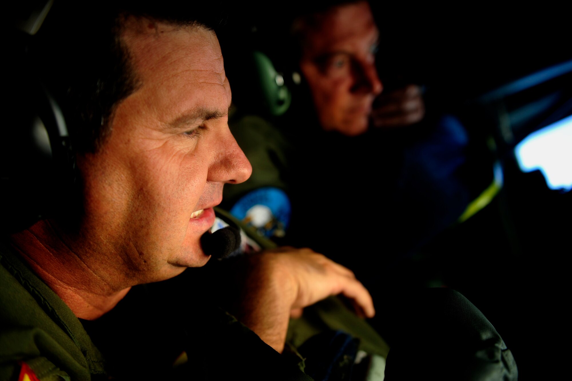 U.S. Air Force Master Sgts. Alvin Kuper, left, a boom operator, assigned to the 465th Air Refueling Squadron, Tinker Air Force Base, Okla., and Jeremy T. Lock, a combat photographer with the 1st Combat Camera Squadron, Joint Base Charleston, S.C., discuss refueling procedures during a mission aboard a KC-135 Stratotanker in support of exercise Rim of the Pacific (RIMPAC) over the Hawaiian operating area, on July 8, 2010.  RIMPAC 2010 is the 22nd in a series of significant international combined/joint military exercises scheduled biennially by U.S. Pacific Fleet and takes place in the Hawaiian operating area.  RIMPAC training operations include participation by more than 14 nations, 34 ships, five submarines, more than 100 aircraft, and more than 20,000 Soldiers, Sailors, Marines and Airmen.  Multilateral exercises such as RIMPAC enhance cooperation between partnering nations and provides a unique opportunity to practice the abilities to plan, communicate, and execute operations.  (U.S. Air Force photo by Staff Sgt. Kamaile O. Long/Released)
