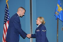 Lt. Col. Bruce Heseltine, 911th commander, congratulates Senior Airman Nicole Barry on her promotion. (USAF photo by SSgt. Terrica Jones, 916ARW/PA)