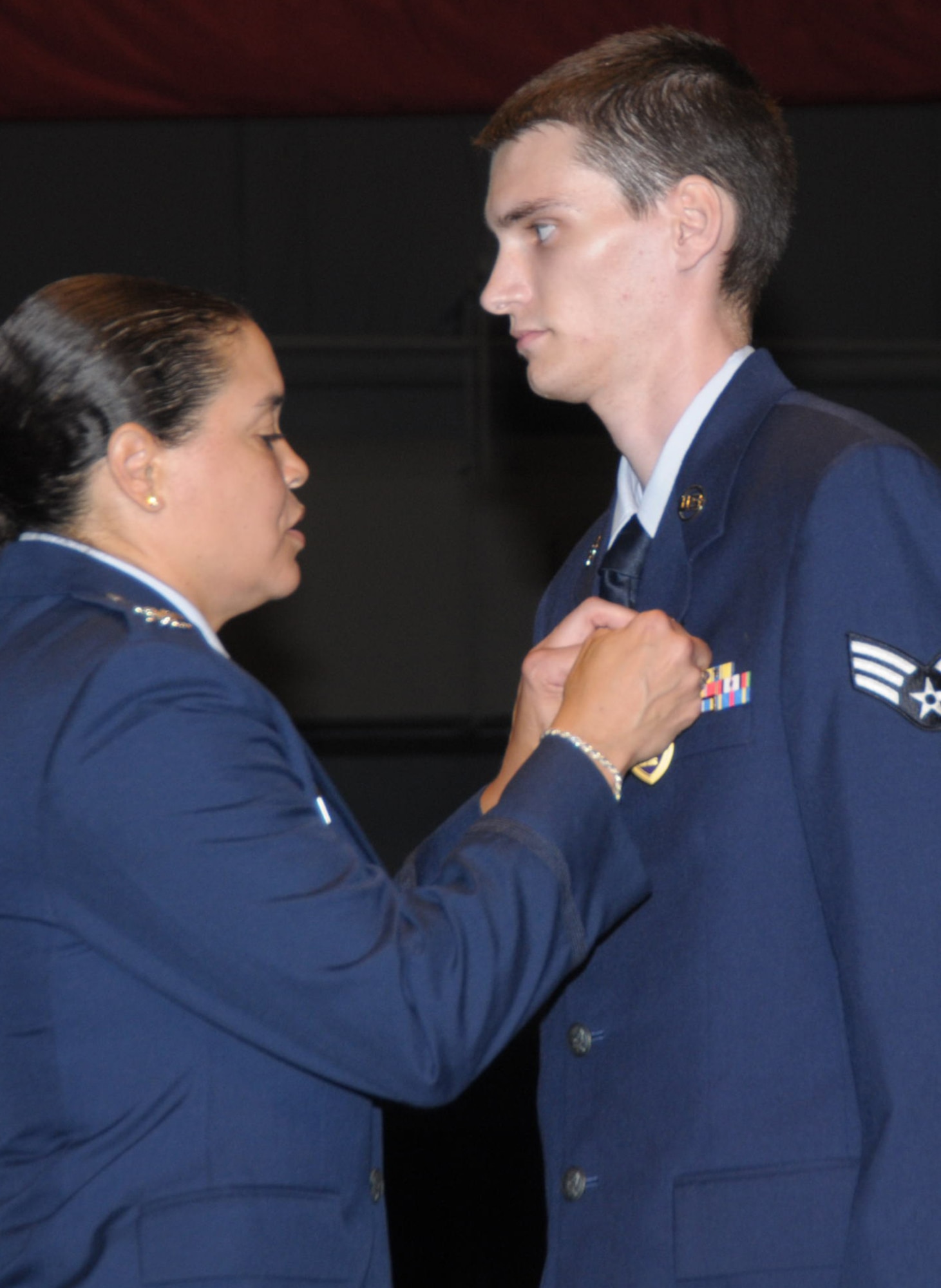 Col. Amanda Gladney pins the Purple Heart on the chest of Senior Airman Tre Porfirio July 8, 2010 at the National Museum of the U.S. Air Force.  Airman Porfirio was one of more than 120 Airmen and family members who participated in the 15th Heroes Welcoming Heroes event held three times per year at Wright-Patterson Air Force Base, Ohio. Colonel Gladney is 88th Air Base Wing commander and Airman Porfirio is a communications-computer systems specialist with the 88th Communications Squadron who was wounded in Afghanistan in November 2009. (U.S. Air Force/Al Bright)