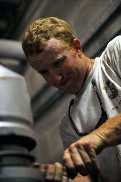 MOODY AIR FORCE BASE, Ga.-- Chris Gaskins, 23rd Civil Engineer Squadron heating, ventilation, air conditioning and refrigeration technician, puts the finishing touches on a boiler stack here July 7. The boiler stack prevents harmful gases from entering the building. (U.S. Air Force photo by Staff Sgt. Schelli Jones/RELEASED)