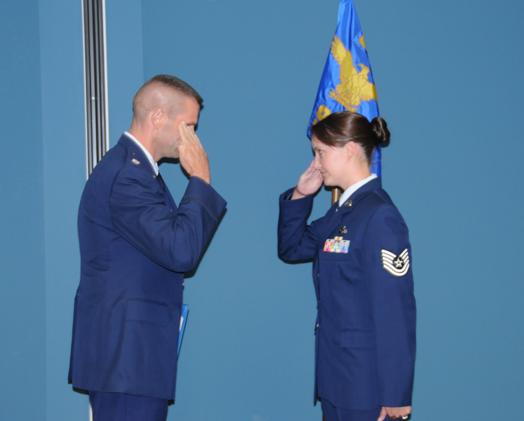 Amy Eveslage, salutes Lt. Col. Bruce Heseltine, upon her promotion to master sergeant. Sergeant Eveslage is an Airman with the 911th Air Refueling Squadron. (USAF photo by SSgt. Terrica Jones, 916ARW/PA)