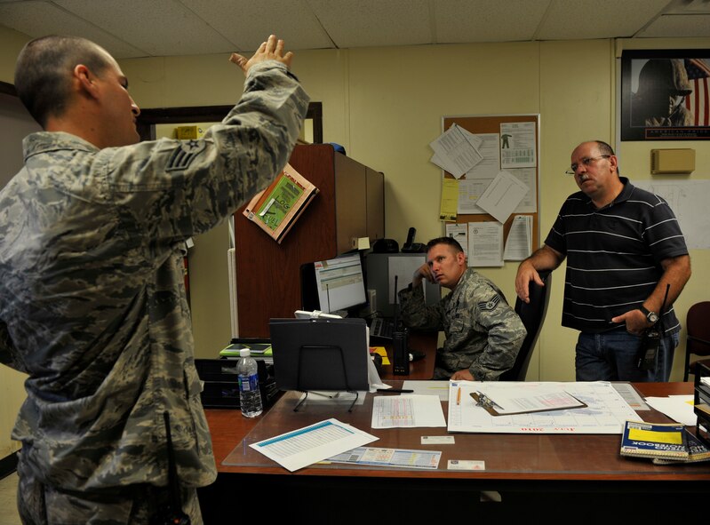MOODY AIR FORCE BASE, Ga.-- Senior Airman Steven Kindle, 23rd Civil Engineer Squadron heating, ventilation, air conditioning and refrigeration journeyman, explains a problem with an AC unit to Staff Sgt. Craig Nutting, 23rd CES HVAC/R craftsmen and Jose Hernandez, 23rd CES HVAC/R supervisor here July 7. If any difficulties arise while working on a job, the shop members can always look for guidance from their experienced shop foremen and peers. (U.S. Air Force photo by Staff Sgt. Schelli Jones/RELEASED)