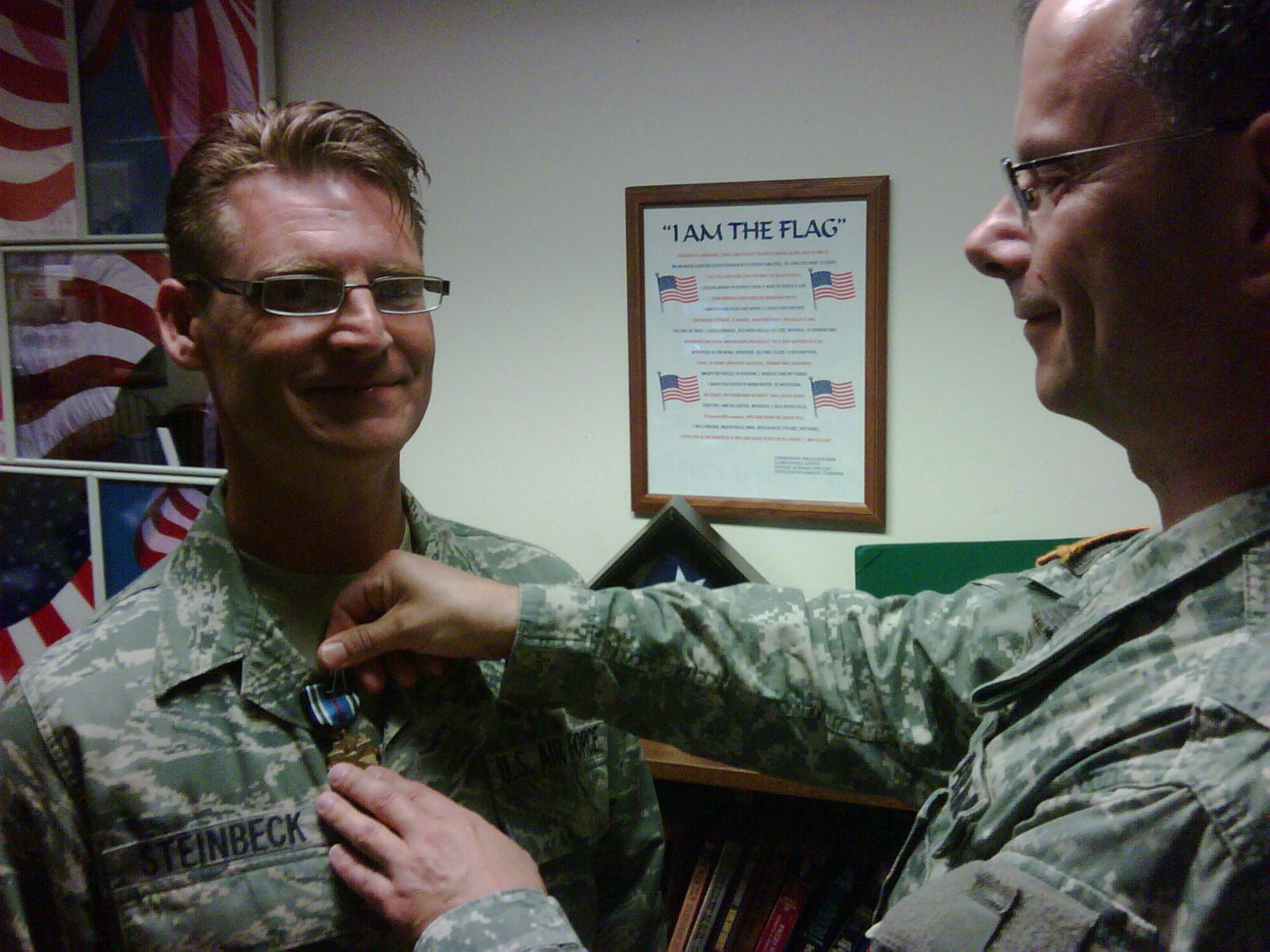 Senior Airman John Steinbeck, a Reservist with the 916th Logistics Readiness Squadron, receives the Joint Service Achievement Medal for his one year tour supporting the Defense Finance Agency. Airman Steinbeck met his former supervisor, Army Col. Rutkowski, at Raleigh Durham Airport for the pinning. (USAF courtesy photo)