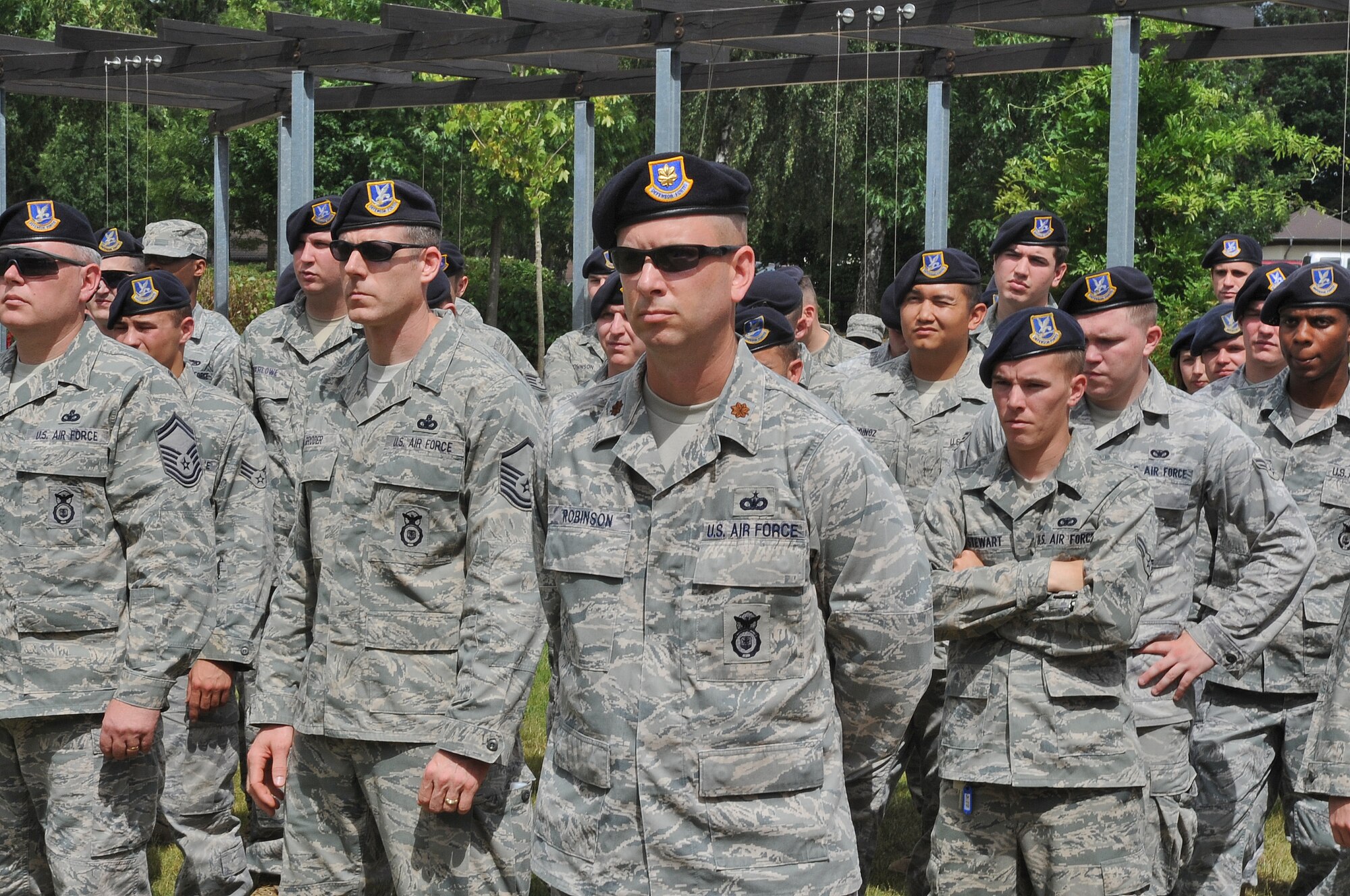 SPANGDAHLEM AIR BASE, Germany – Maj. Michael Robinson,52nd Security Forces Squadron commander, stands at parade rest with his Airmen and watches Col. Tip Wight, 52nd Fighter Wing commander, give a speech about how well the Sabers performed during the 2010 USAFE ORI during a recognition barbecue July 9. The wing earned an overall excellent rating on the inspection, which was designed to test a unit's ability to respond to contingency operations. (U.S. Air Force photo/Airman 1st Class Nick Wilson)
