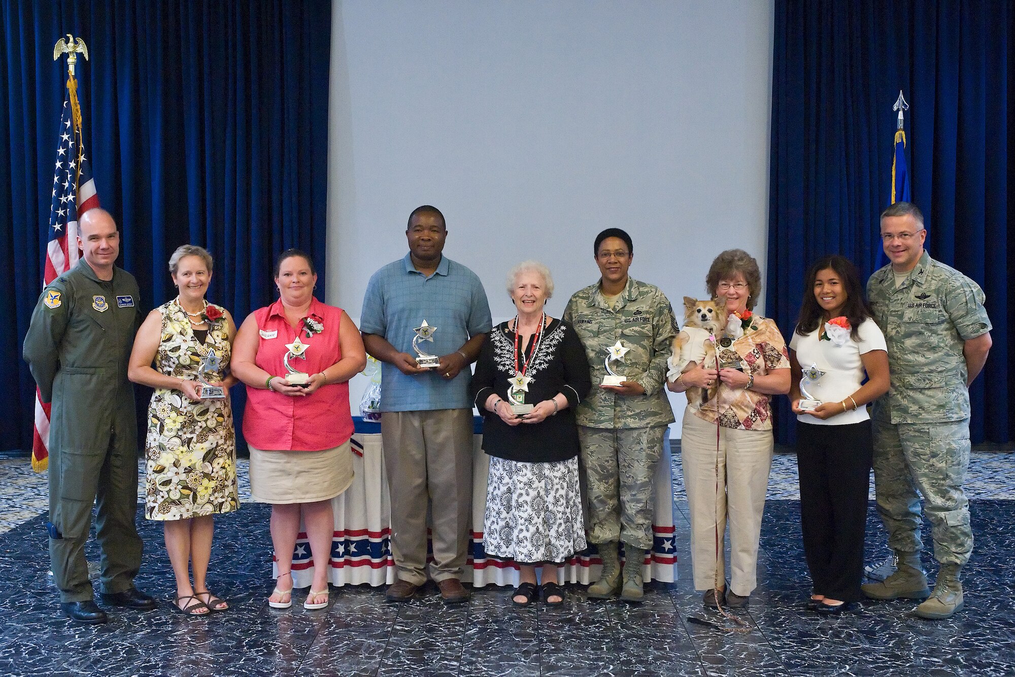 (From left to right) Col. Mason Morris, 436th Airlift Wing commander; Kathryn Cocklin, Officers Spouses Club award winner; Suzanne Bump, Enlisted Spouses Club award winner; Joseph Flamer, Dover Air Force Base Youth Center Parent award winner; Doris Vrhovac, Medical Group Pharmacy award winner; Janet Hawkins, 512th Airlift Wing award winner; Angel and Nancy Dunn, 436th Force Support Squadron award winners; Darlene Budago, DAFB Youth award winner; and Col. Randal Bright, 512th Airlift Wing commander.  Angel is the first canine to win an award. She is a licensed Medical Therapy Dog who has served at Bayhealth for five years. (U.S. Air Force photo by Roland Balik/Released) 