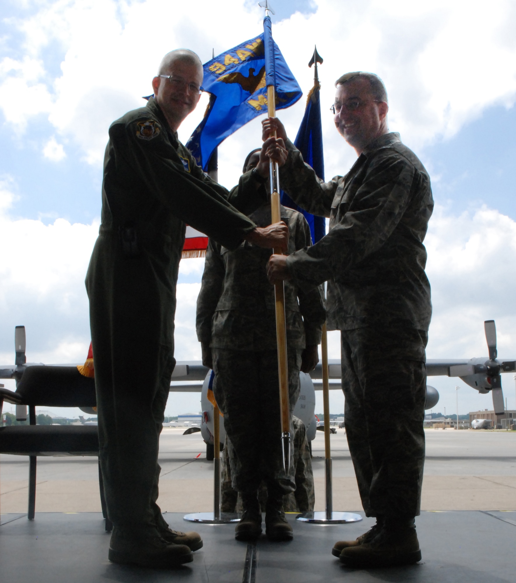 Col. Patrick W. Webb receives guidon from Col. Timothy E. Tarchick, 94th Airlift Wing Commander, to commemorate his assumption of command of the 94th Airlift Wing Maintenance Group here July 10. (U.S. Air Force photo by Airman 1st Class Campbell)