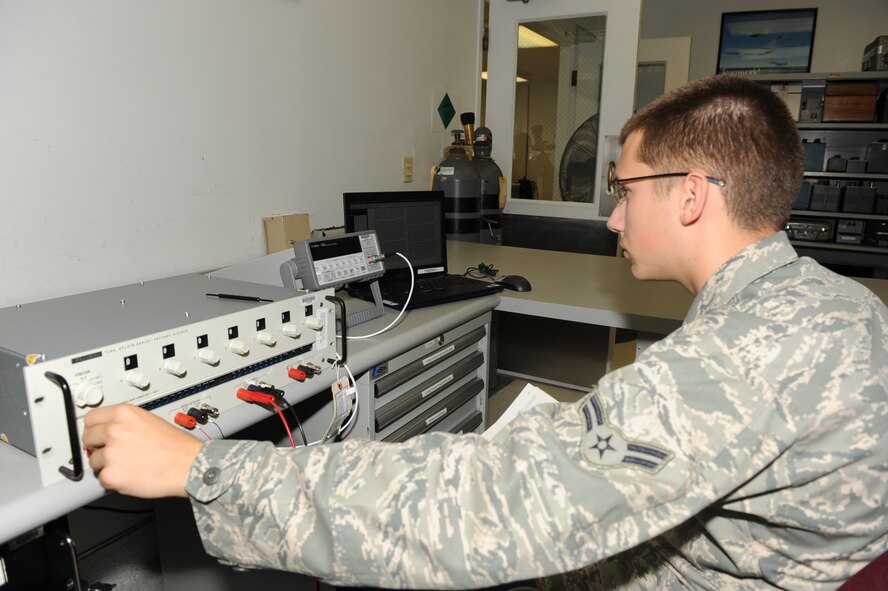 SEYMOUR JOHNSON AIR FORCE BASE, N.C. -- Airman 1st Class William Harris prepares a voltage divider to perform a digital multimeter calibration here July 8, 2010. Many base agencies use multimeters for voltage measurements and electronic circuit maintenance operations.  Airman Harris is assigned to the 4th Component Maintenance Squadron as a test measurement and diagnostic equipment technician and hails from Phenix City, Ala. (U.S. Air Force photo/Senior Airman Gino Reyes)