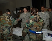 KUNSAN AIR BASE, Republic of Korea -- Wolf Pack personnel check identification of incoming Airmen during a Personnel Deployment Reception Function here July 13. PDRF is a quick way to in process and give information to follow on forces, to take the fight north. (U.S. Air Force photo/Senior Airman Roy Lynch)