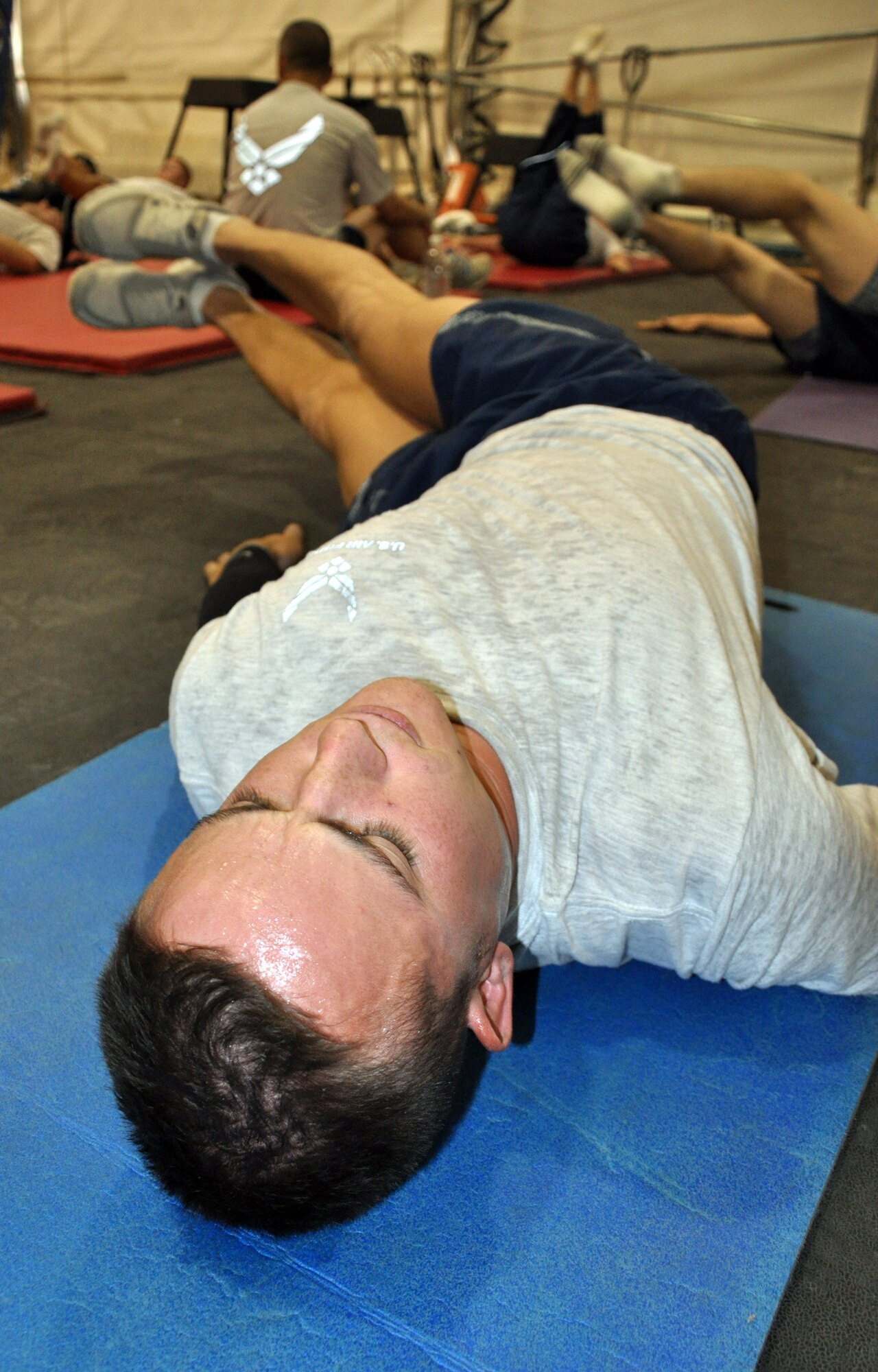 Staff Sgt. Simeon Sharp, a member of the 447th Civil Engineering Squadron, Sather Air Base, Baghdad, volunteers his off-duty time to lead an abdominal exercise class at the base gym.  He is a member of the Utah Air National Guard.  (U.S. Air Force photo by Tech. Sgt. Mike Edwards)