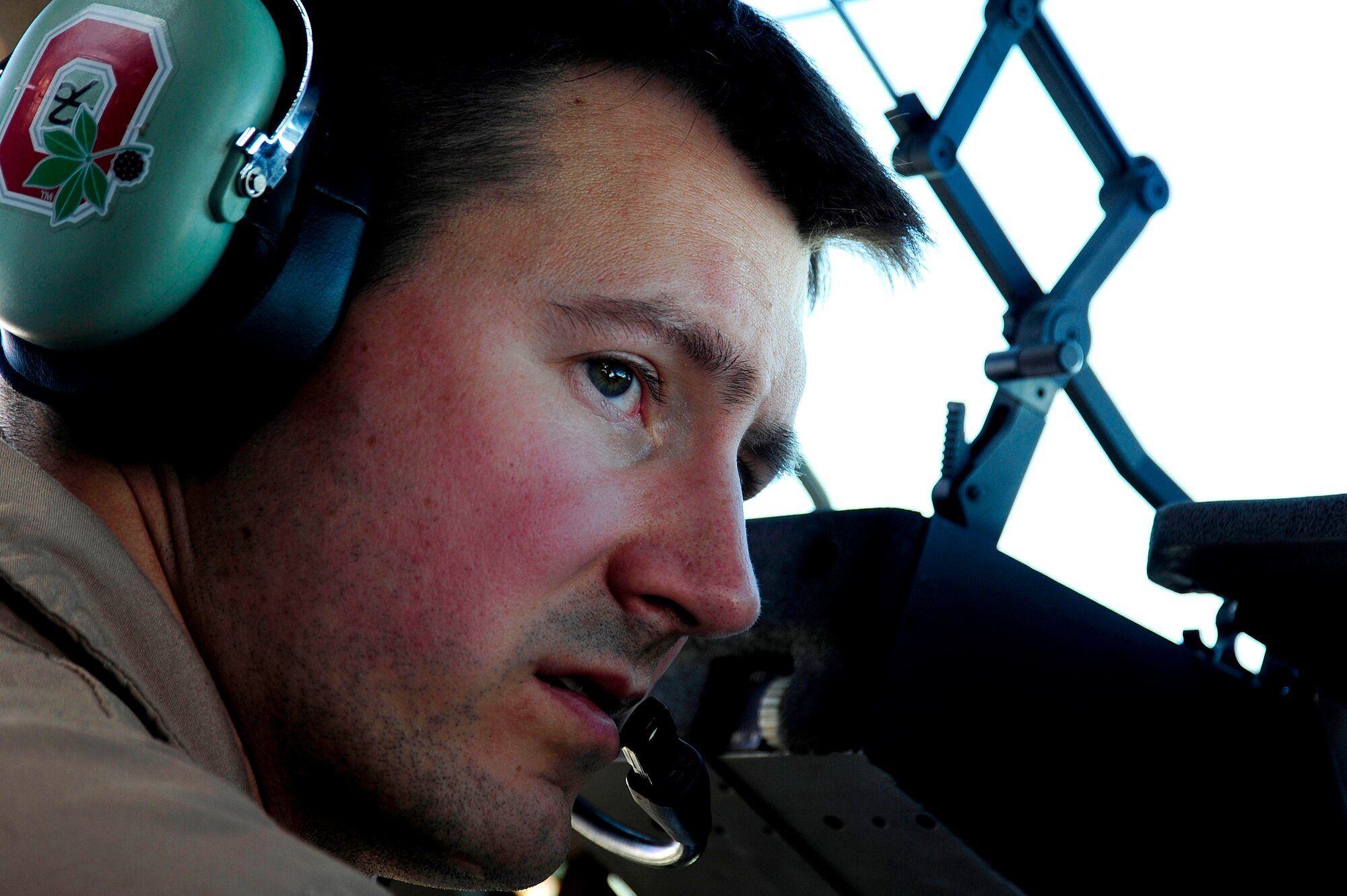 U.S. Air Force Capt. Kevin Kretz, a C-17 Globemaster III pilot assigned to the 816 Expeditionary Airlift Squadron, talks with his co-pilot during a routine airlift to Baghdad, Iraq, while deployed to an undisclosed location in Southwest Asia on July 6, 2010. (U.S. Air Force photo by Staff Sgt. Andy M. Kin / Released)