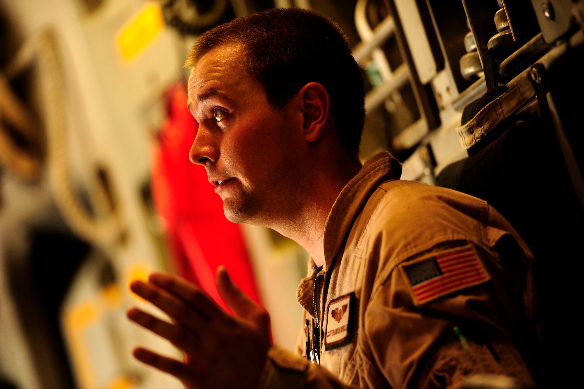 U.S. Air Force Staff Sgt. Brandon Nontelle, a C-17 Globemaster III loadmaster instructor assigned to the 816th Expeditionary Airlift Squadron, talks procedures and guidelines with members of crew during a flying mission to Baghdad, Iraq, from an undisclosed location in Southwest Asia on July 6, 2010. (U.S. Air Force photo by Staff Sgt. Andy M. Kin / Released)
