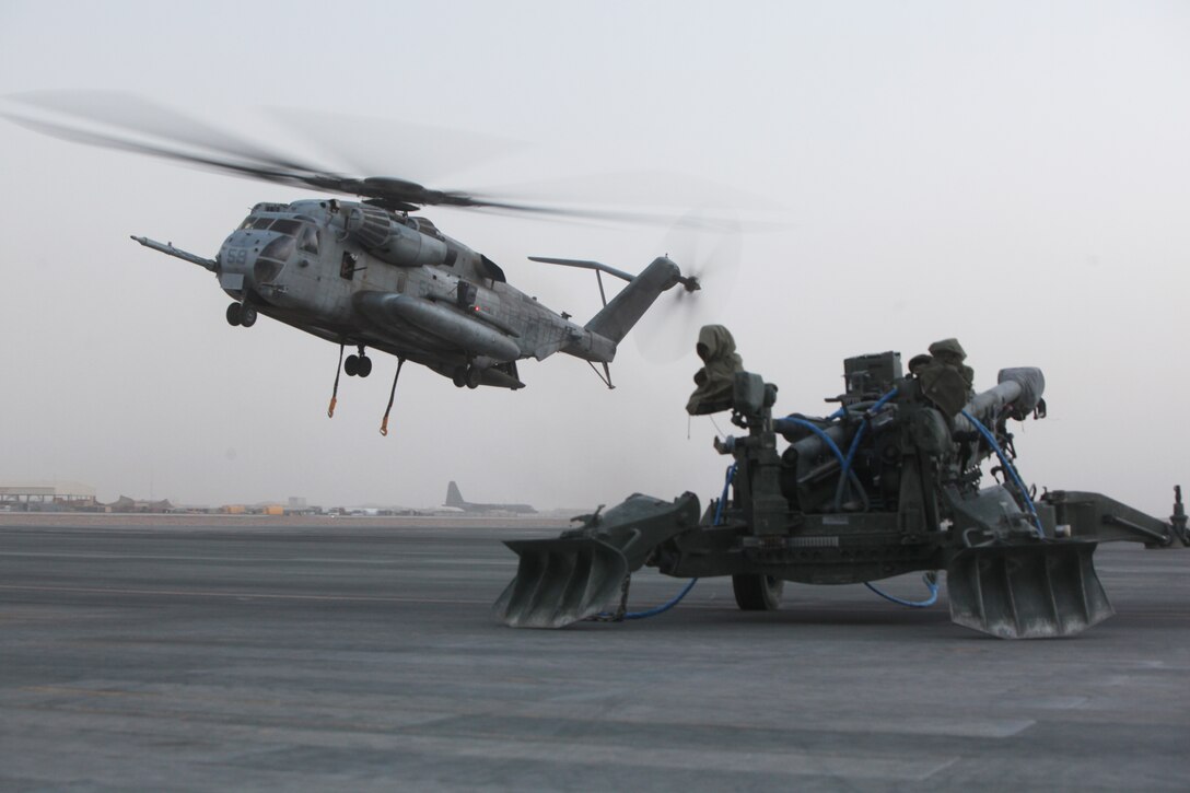 A CH-53E approaches an M777 Lightweight Towed Howitzer to be lifted with the assistance of a helicopter support team (not shown), Headquarters and Service Company, 1st Marine Logistics Group (Forward) aboard Camp Bastion, Helmand province, Afghanistan, July 13, 2010. HSTs are tasked with assisting heavy lift operations in support of the International Security Assistance Force.