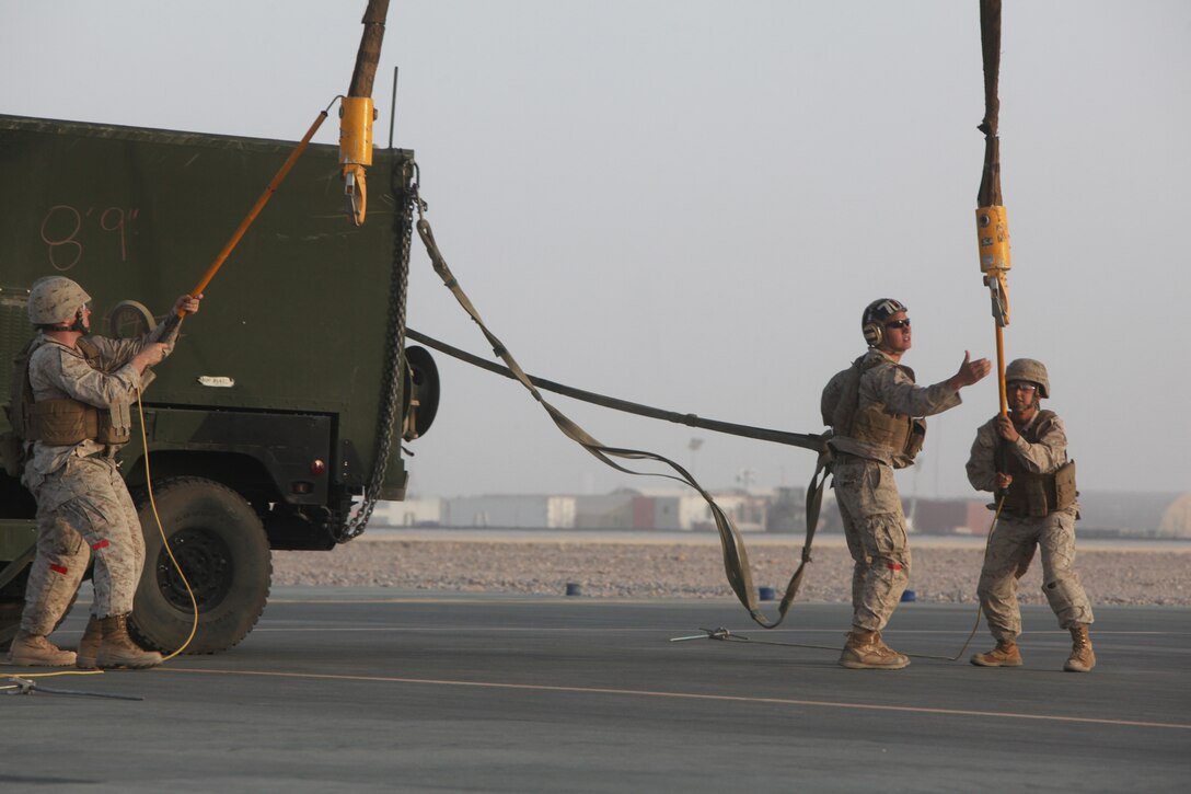 A helicopter support team, Headquarters and Service Company, 1st Marine Logistics Group (Forward), attaches a Humvee to a CH-53E Super Stallion (not shown) for transport from Camp Bastion, Helmand province, Afghanistan, July 13, 2010. HSTs are tasked with assisting heavy lift operations in support of the International Security Assistance Force.