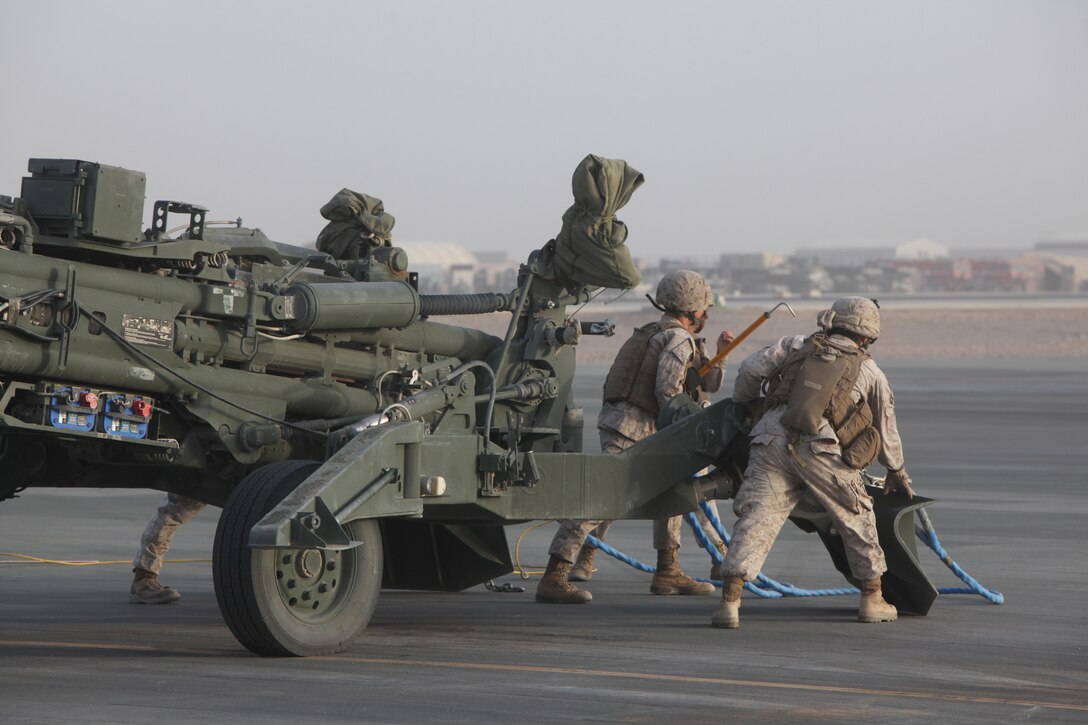 The helicopter support team, Headquarters and Service Company, 1st Marine Logistics Group (Forward), prepares to attach an M777 Howitzer cannon to a CH-53E Super Stallion (not shown) to be transported from Camp Bastion, Helmand province, Afghanistan, July 13, 2010. The HST is tasked with assisting heavy lift operations in support of the International Security Assistance Force.