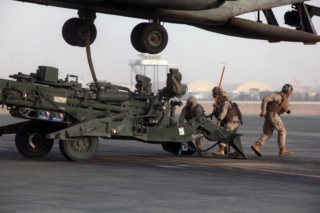 A helicopter support team, Headquarters and Service Company, 1st Marine Logistics Group (Forward), prepares to attach an M777 Lightweight Towed Howitzer to a CH-53E Super Stallion for transport from Camp Bastion, Helmand province, Afghanistan, July 13, 2010. HSTs are tasked with assisting heavy lift operations in support of the International Security Assistance Force.
