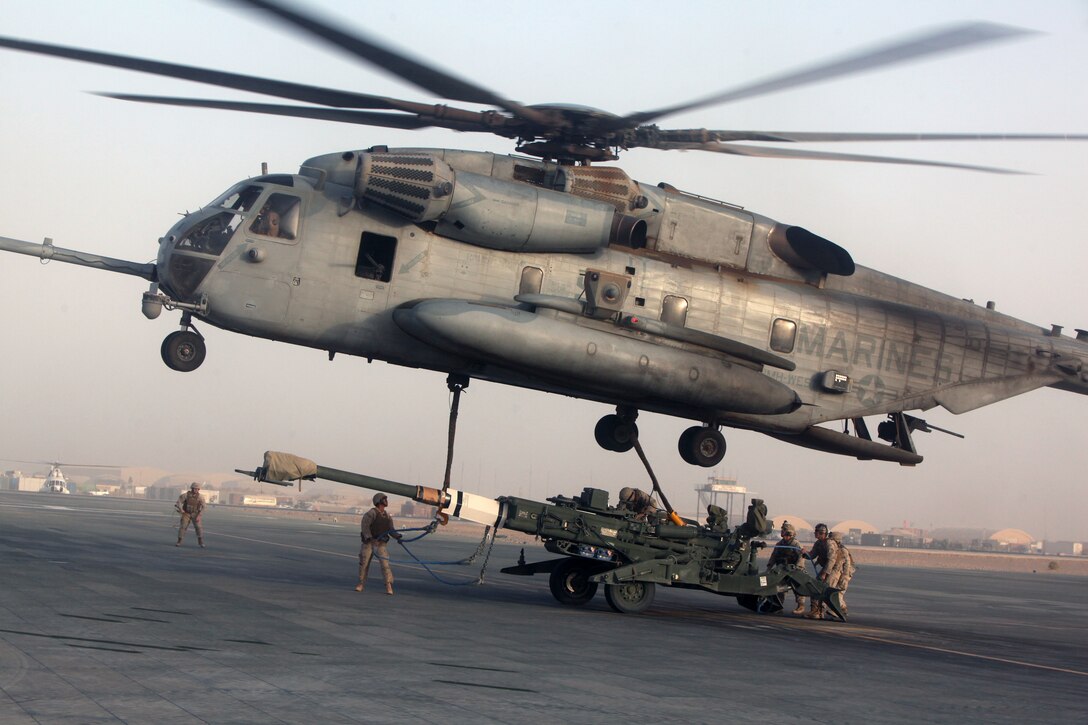 A helicopter support team, Headquarters and Service Company, 1st Marine Logistics Group (Forward), attaches an M777 Lightweight Towed Howitzer to a CH-53E Super Stallion for transport from Camp Bastion, Helmand province, Afghanistan, July 13, 2010. HSTs are tasked with assisting heavy lift operations in support of the International Security Assistance Force.