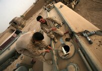HELMAND PROVINCE, Afghanistan – Marines with Alpha Company, Combat Logistics Battalion 6, 1st Marine Logistics Group (Forward), prepare to gravity feed fuel into stationary tankers at Combat Outpost Nolay, July 13. A combat logistics patrol numbering more than three dozen vehicles arrived with fuel and communications and computer equipment after nearly two days of crawling through improvised explosive device-laden desert. The gear will enable American forces in Helmand’s volatile Sangin district to establish their own combat operations center and increase the general livability at the growing base.
