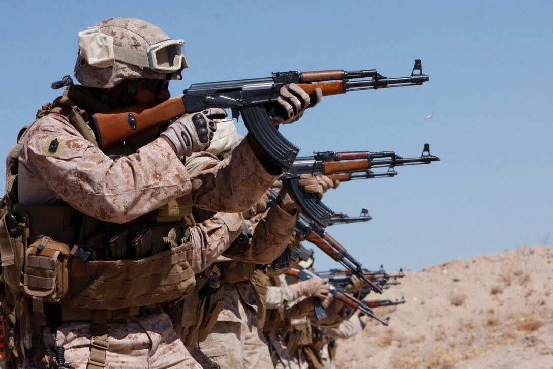 Marines training with the Combat Center’s Advisor Training Group fire AK-47s during a Combat Marksmanship Program shoot at Range 113A July 14. The Marines are bound for Operation Enduring Freedom this fall.