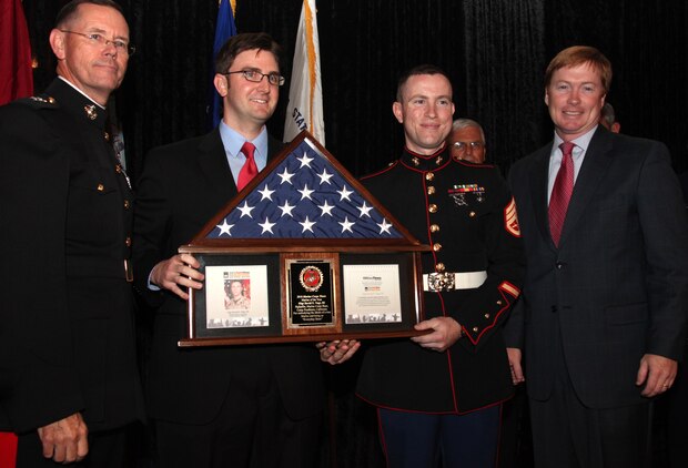 Maj. Gen. Darrell Moore, the director of Reserve Affairs Division, Marine Corps Base Quantico, Va., Andrew deGrandpré, the managing editor of Marine Corps Times, Staff Sgt. David E. Vogt III, the Military Times Marine of the Year, and Adam Putnam, the U.S. Representative for Vogt’s hometown district, pose with Vogt’s award during a ceremony in Washington July 14, 2010. Vogt, the assistant legal chief for the office of the staff judge advocate, Headquarters and Support Battalion, Marine Corps Base Camp Pendleton, Calif., helped organize his battalion’s Noncommissioned Officer Association and served as the inaugural president, as well as volunteered with the Camp Pendleton Animal Shelter, local schools, blood drives and other organizations both on and off base.